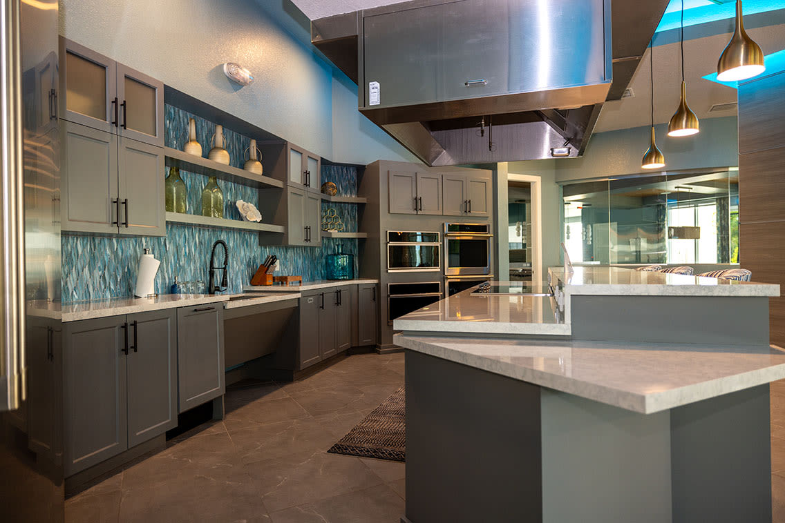 An apartment kitchen with an island at Mallory Square at Lake Nona in Orlando, Florida