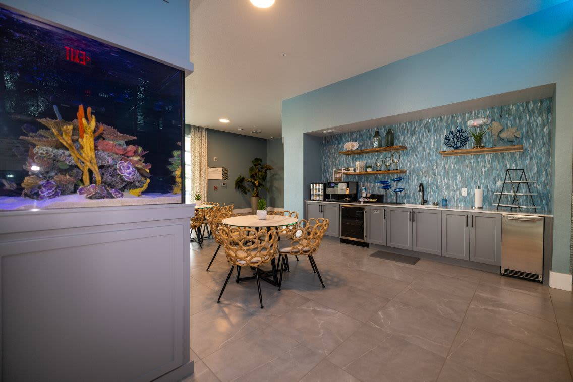 AN apartment dining room, living room and open door to the bedroom at Mallory Square at Lake Nona in Orlando, Florida