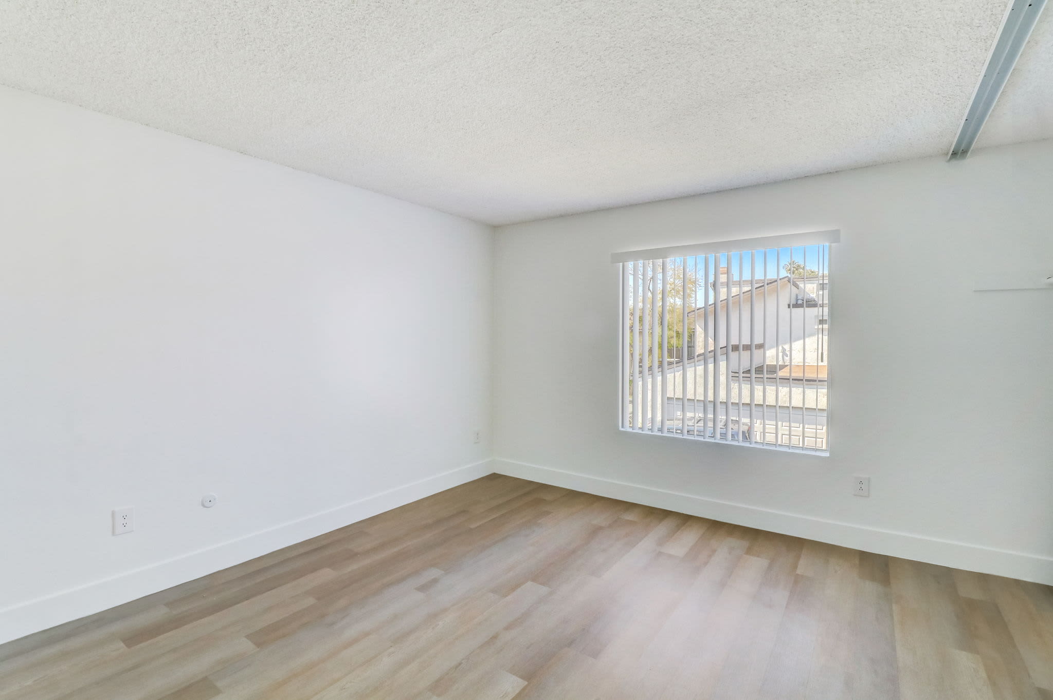 Spacious bedrooms with plank flooring at Terre at Sandalwood in El Cajon, California