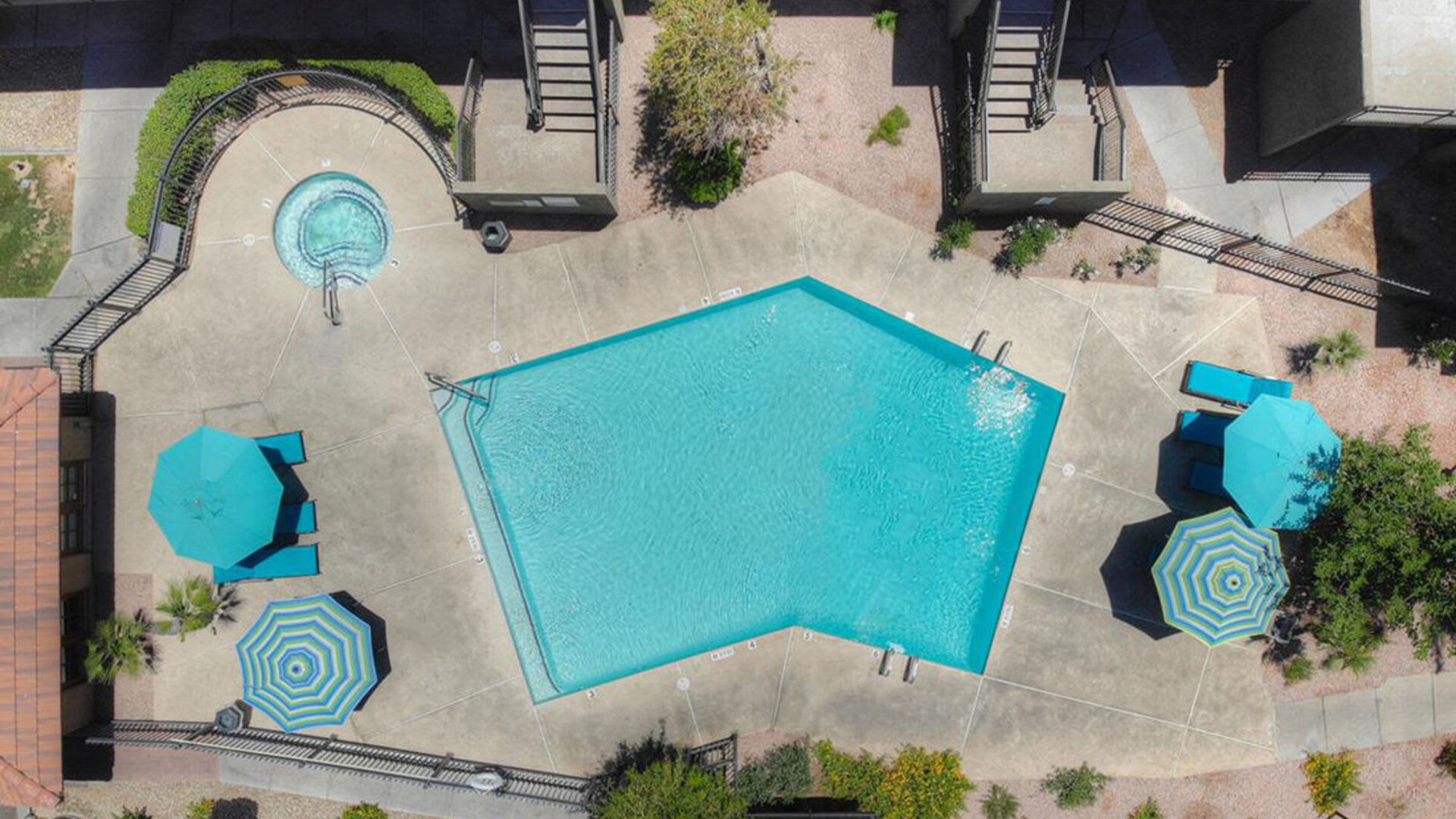 Swimming pool with shade to sit at Raystone Apartments in Phoenix, Arizona