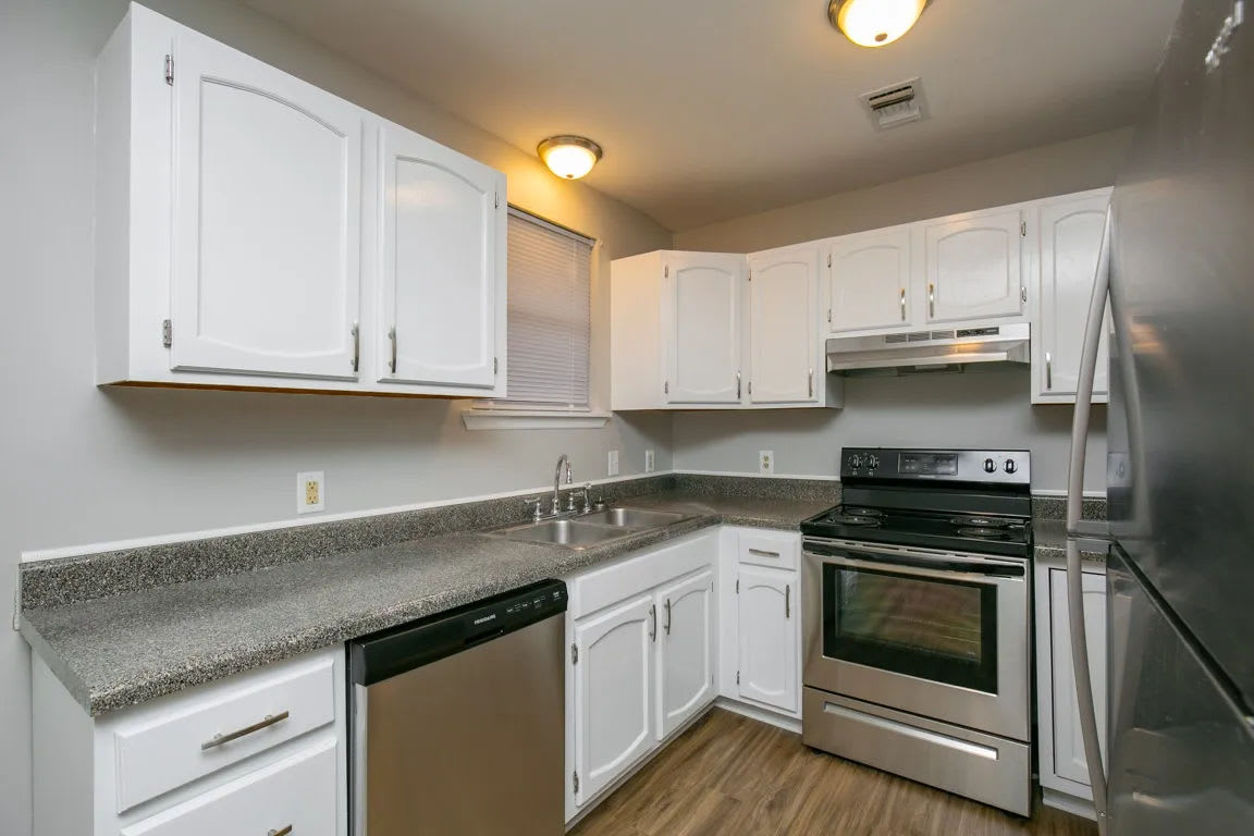 Kitchen with range and wooden cabinetry at Westgate Apartment Homes in Lebanon, Tennessee