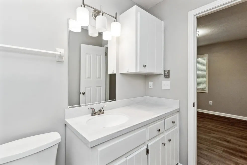 Bathroom with white cabinets and mirror at Skyline Flats in Nashville, Tennessee