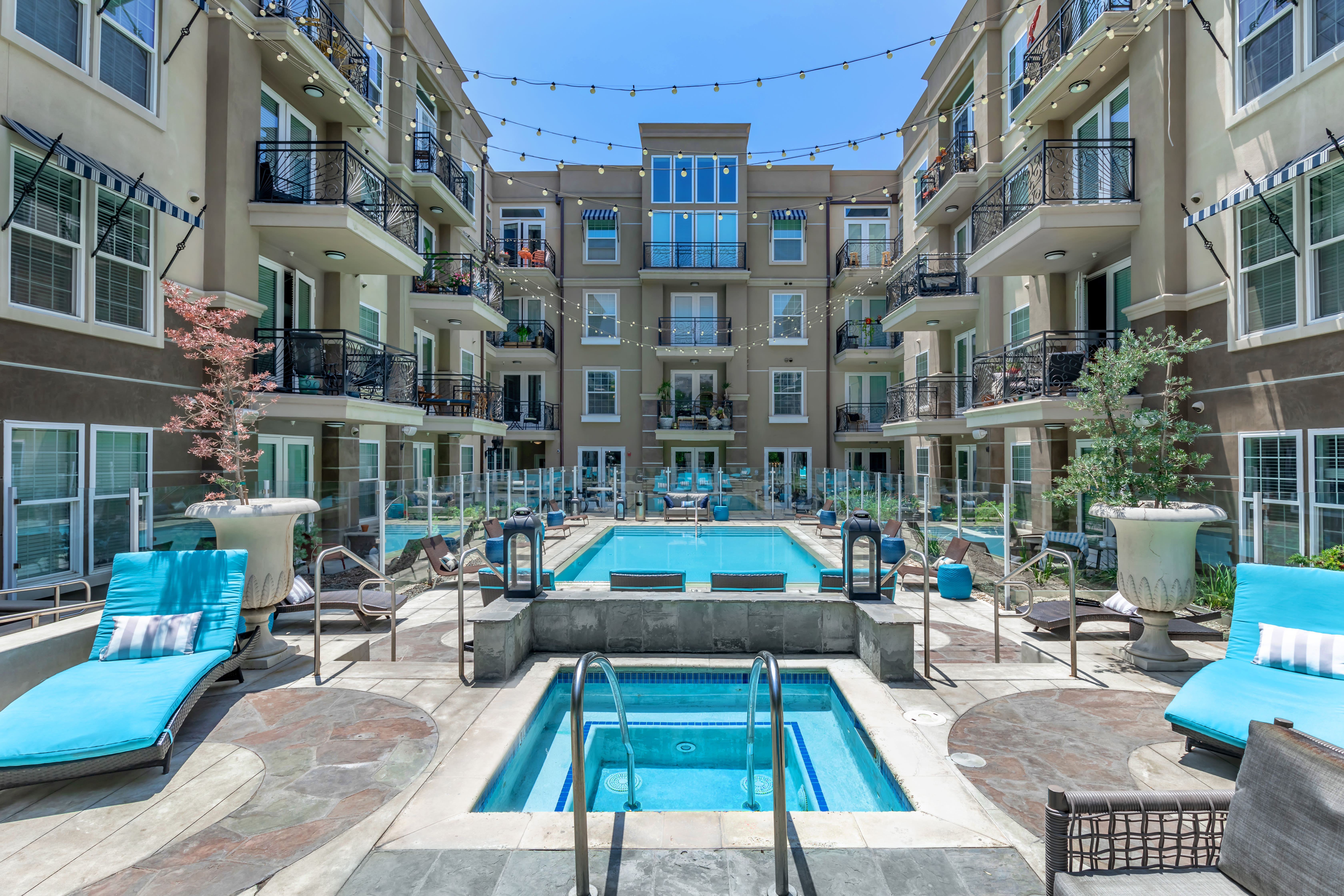 Zero-edge pool and hot tub with a spacious lounge area beside it at La Belle at Hollywood Tower in Los Angeles, California