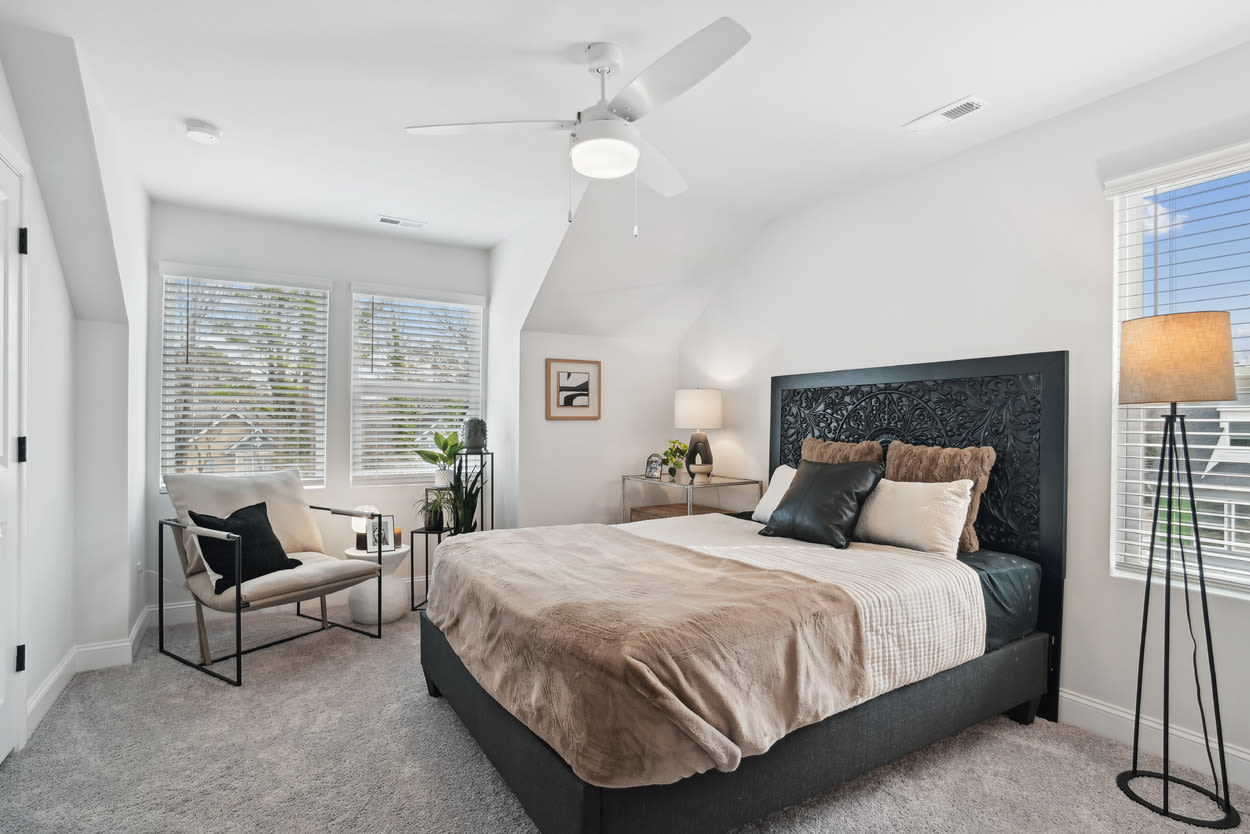 Bedroom with lamp and window at Towns At Eastland in Charlotte, North Carolina