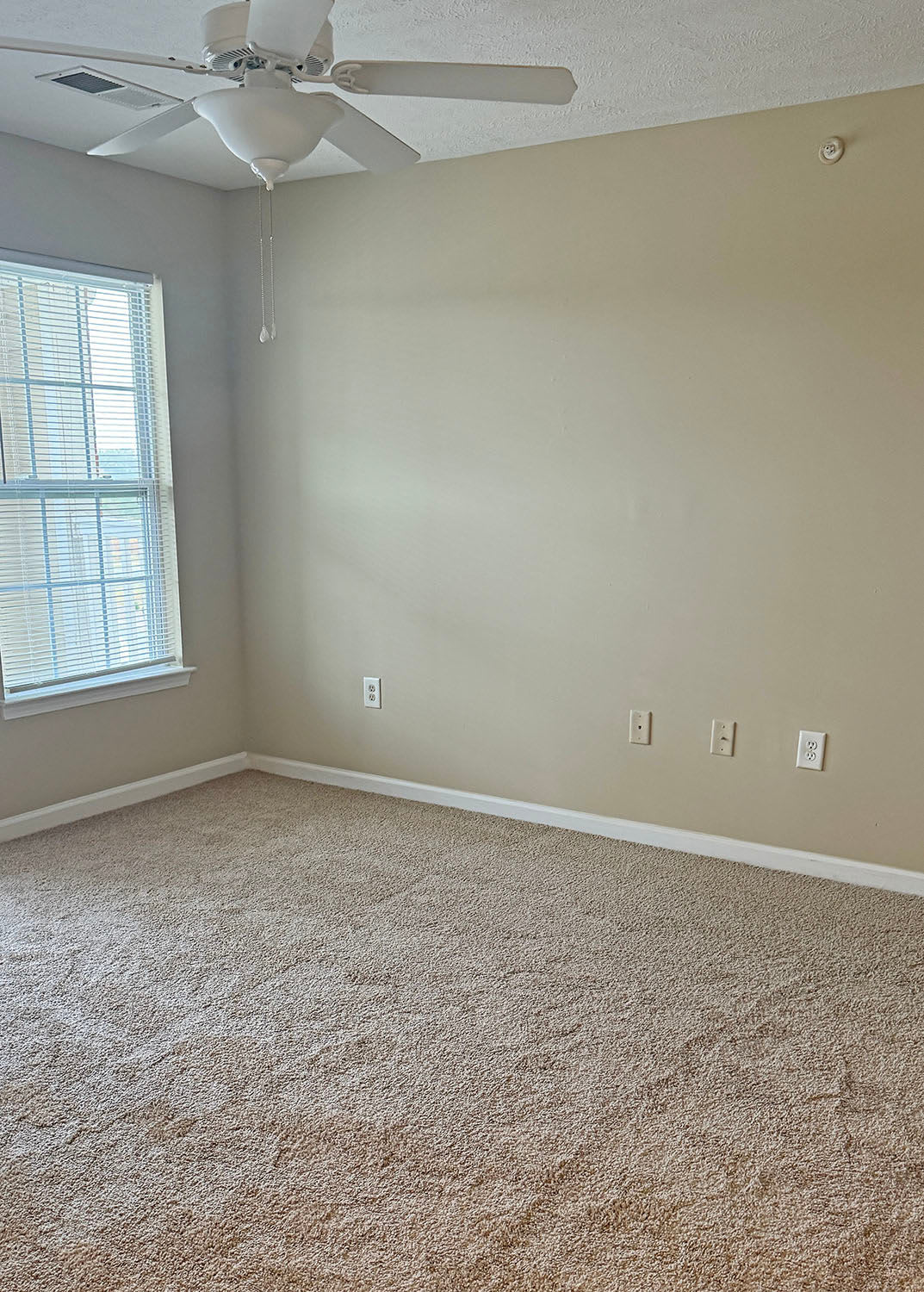 Bedroom with ceiling fan at Coldwater Ridge in Kannapolis, North Carolina