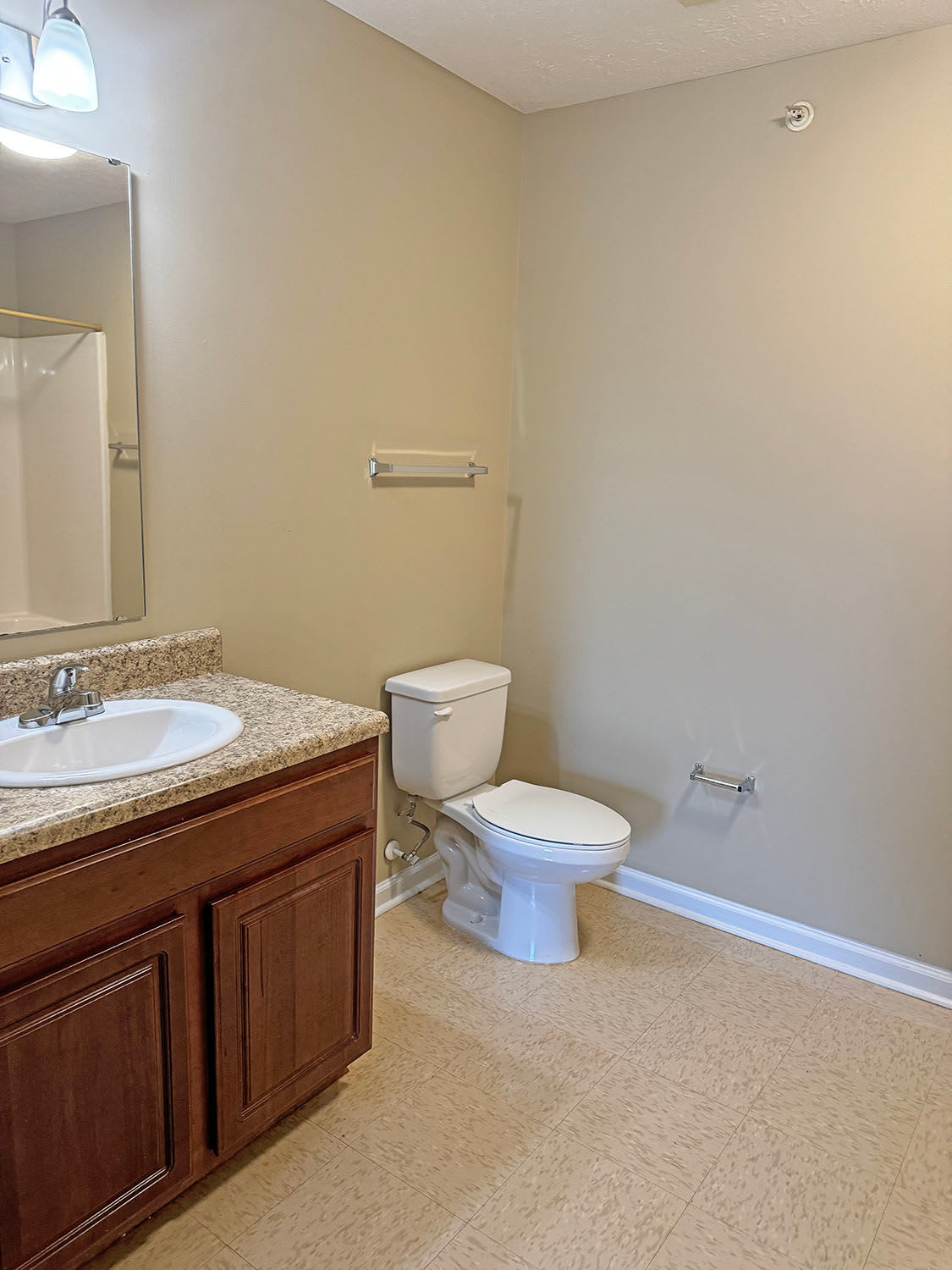 Bathroom with wood cabinets Coldwater Ridge in Kannapolis, North Carolina