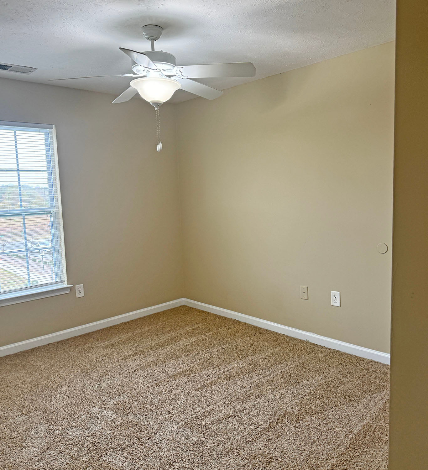 Another view of the bedroom with a ceiling fan Coldwater Ridge in Kannapolis, North Carolina