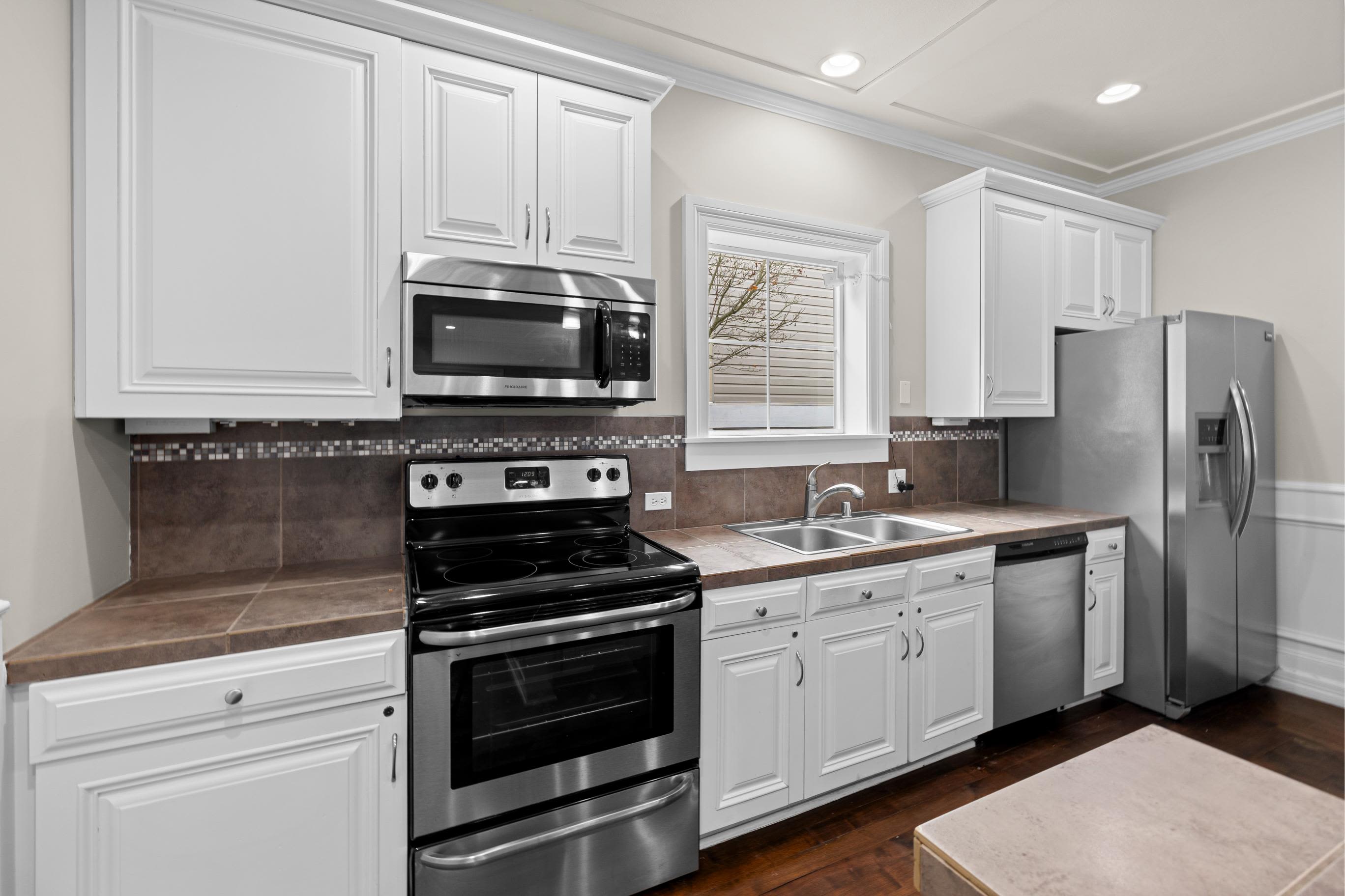Kitchen with white cabinetry at HighGrove Apartments in Everett, Washington