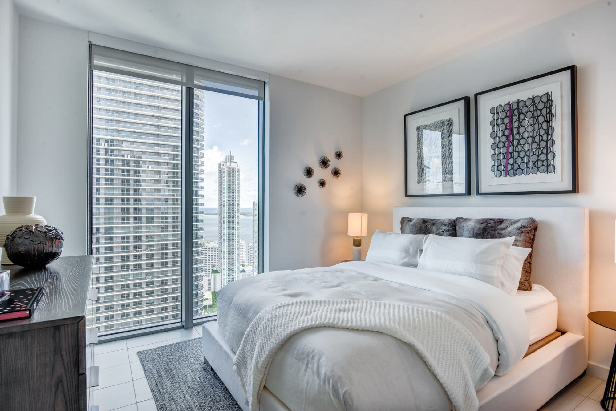 Bright apartment bedroom with large window at Solitair Brickell Apartments in Miami, Florida