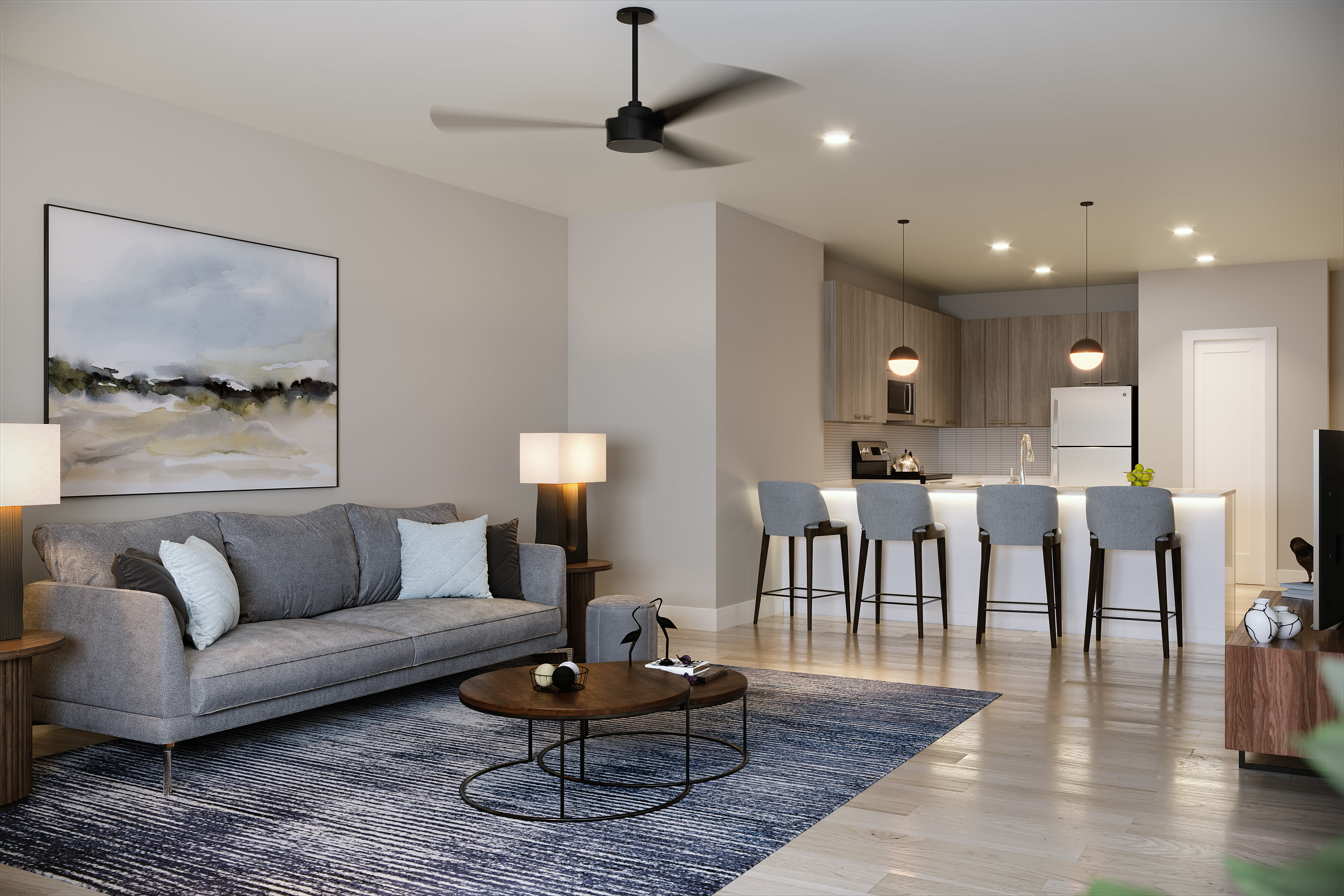 Spacious living room with couch, coffee table and ceiling fan at Stone Village Apartments in Reno, Nevada