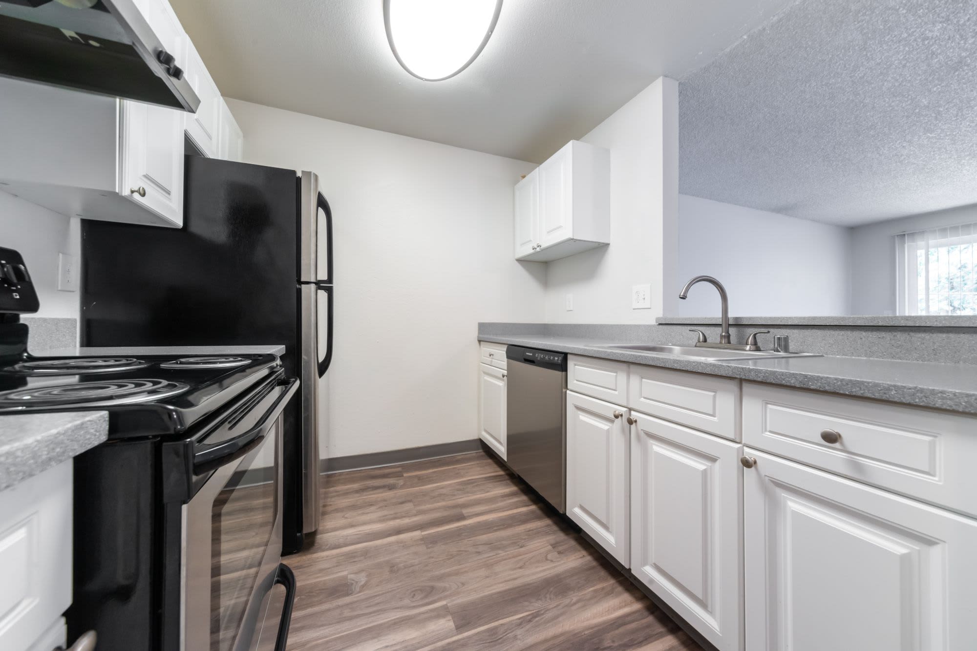 Kitchen with refrigerator, dishwasher and microwave at Solana Apartments in Burien, Washington