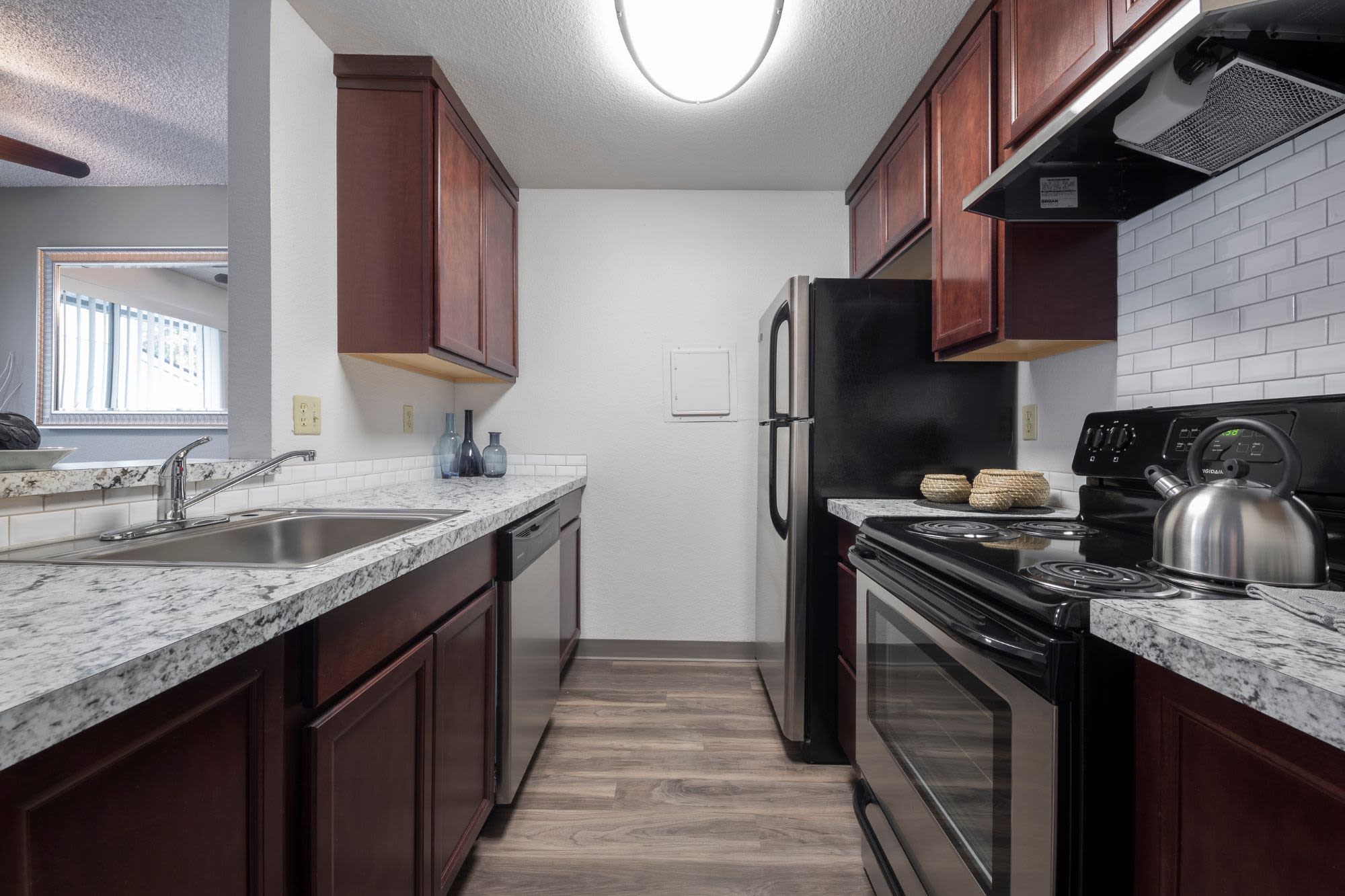 Fully equipped kitchen with hardwood flooring at Solana Apartments in Burien, Washington