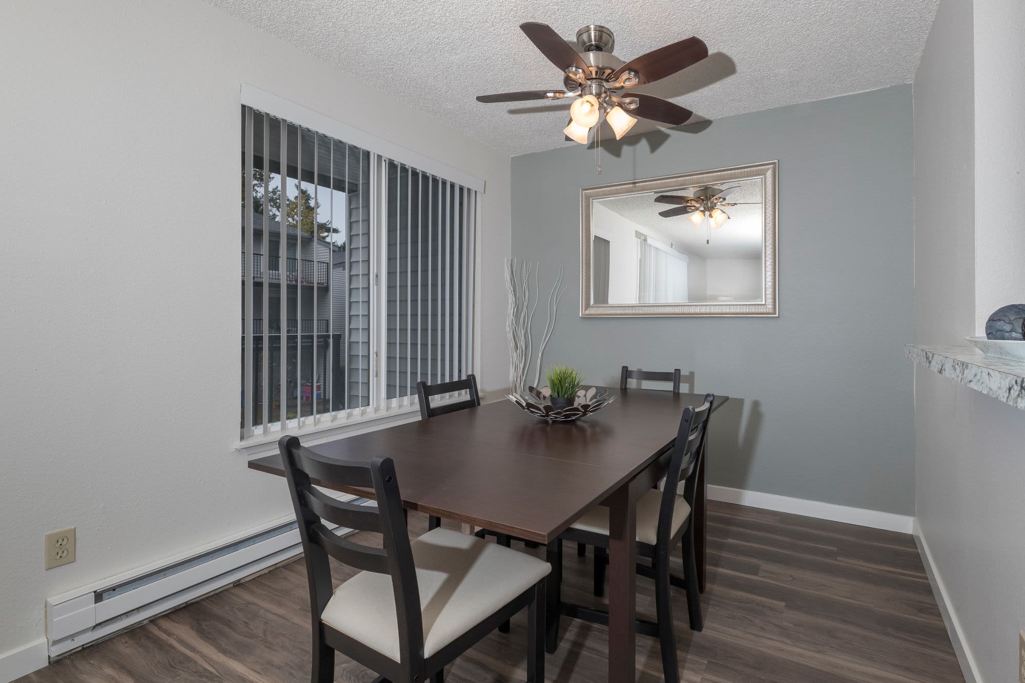 Dining table with close access to fully equipped kitchen at Solana Apartments in Burien, Washington