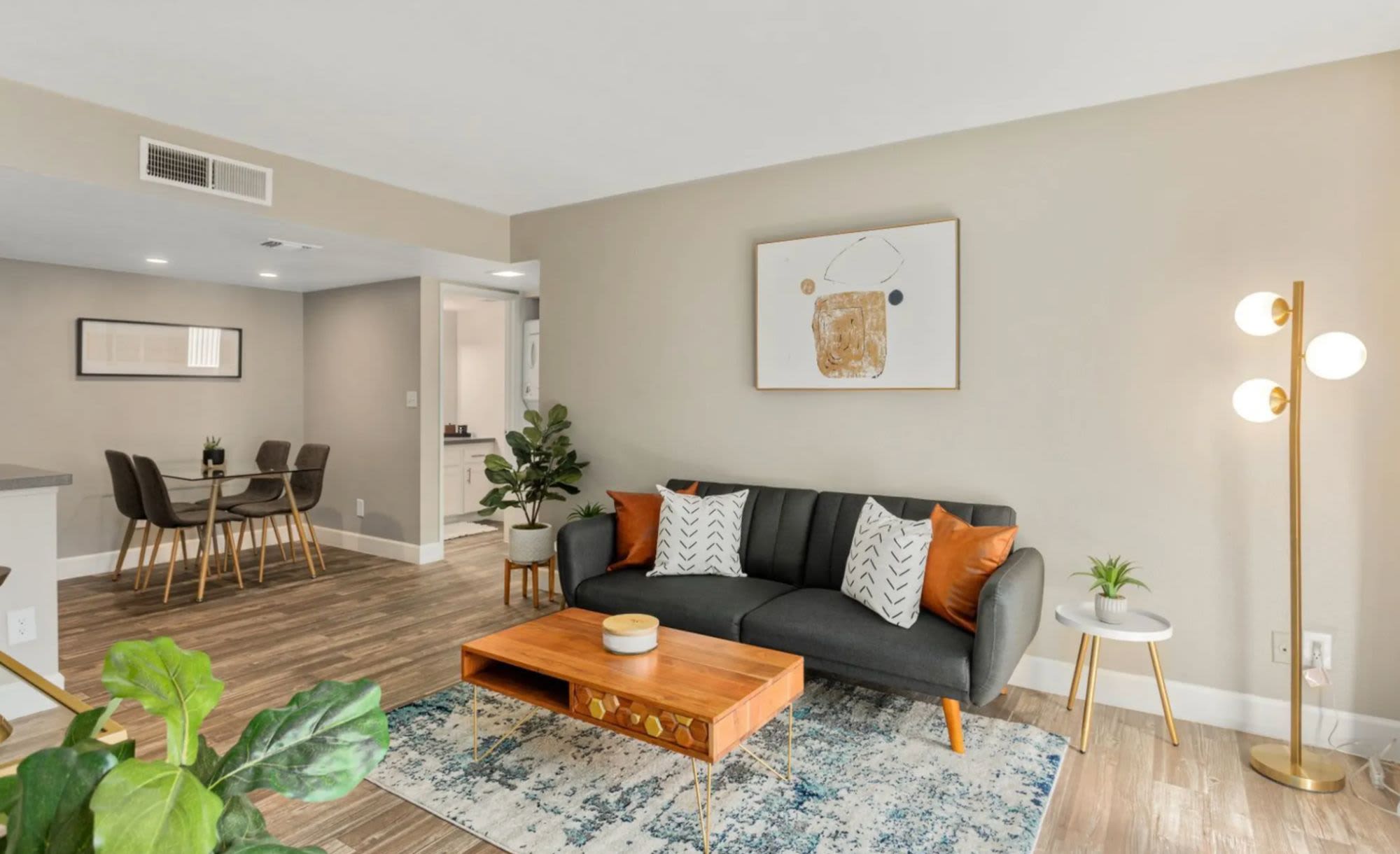 Spacious living room with couch, coffee table and more at Raystone Apartments in Phoenix, Arizona