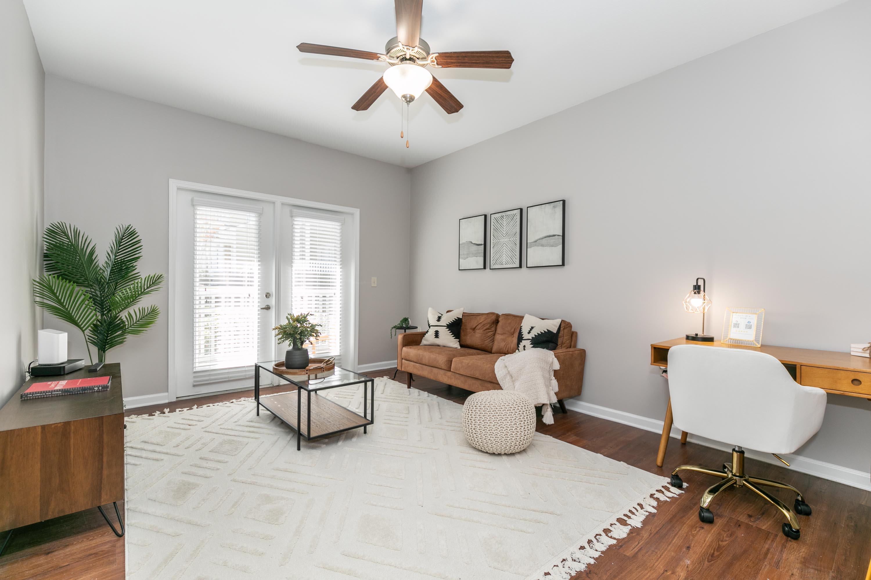 Living room with a sofa, a chair, and a ceiling fan at Thomaston Crossing in Macon, Georgia