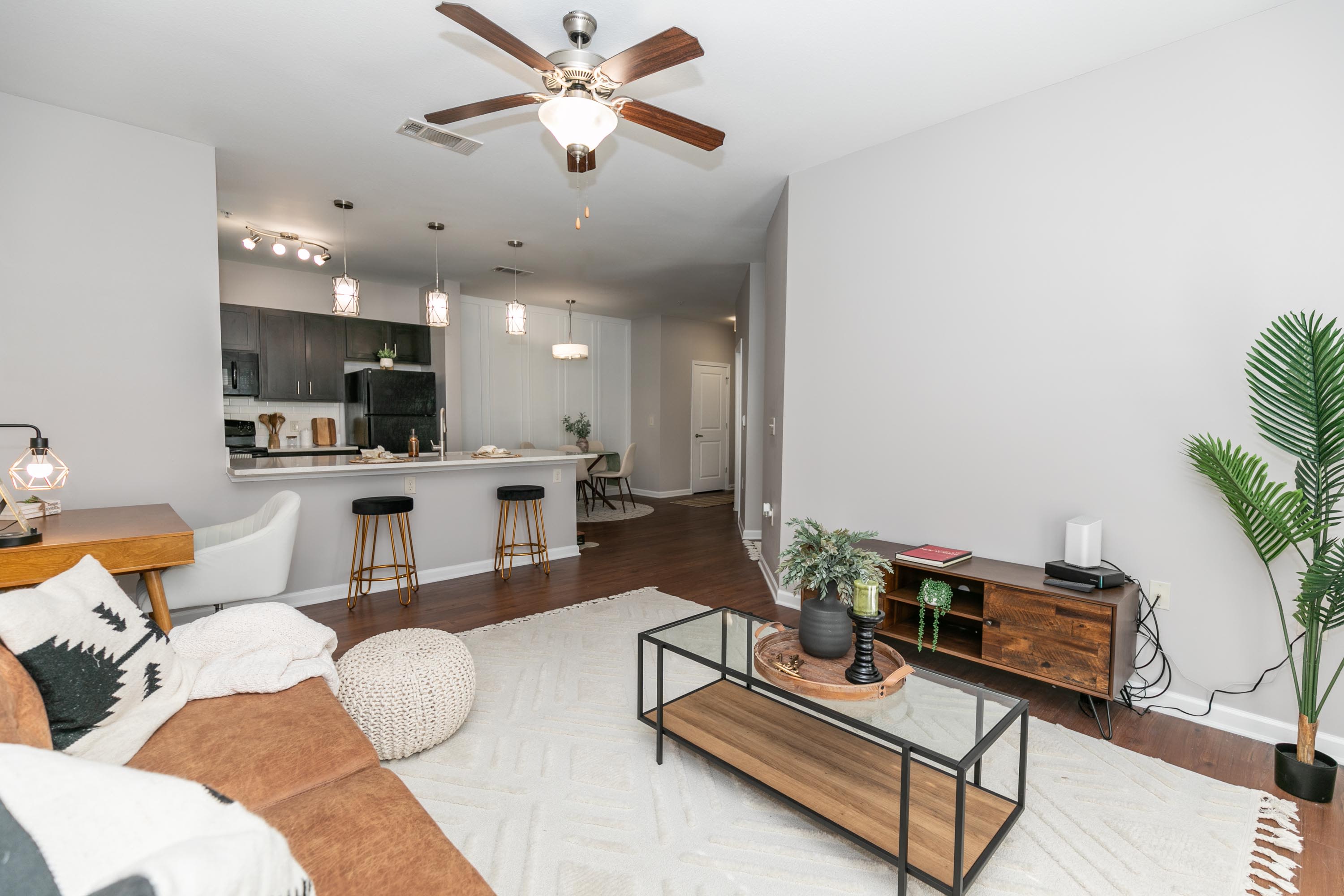 Living room with a sofa, a coffee table, and a ceiling fan at Thomaston Crossing in Macon, Georgia