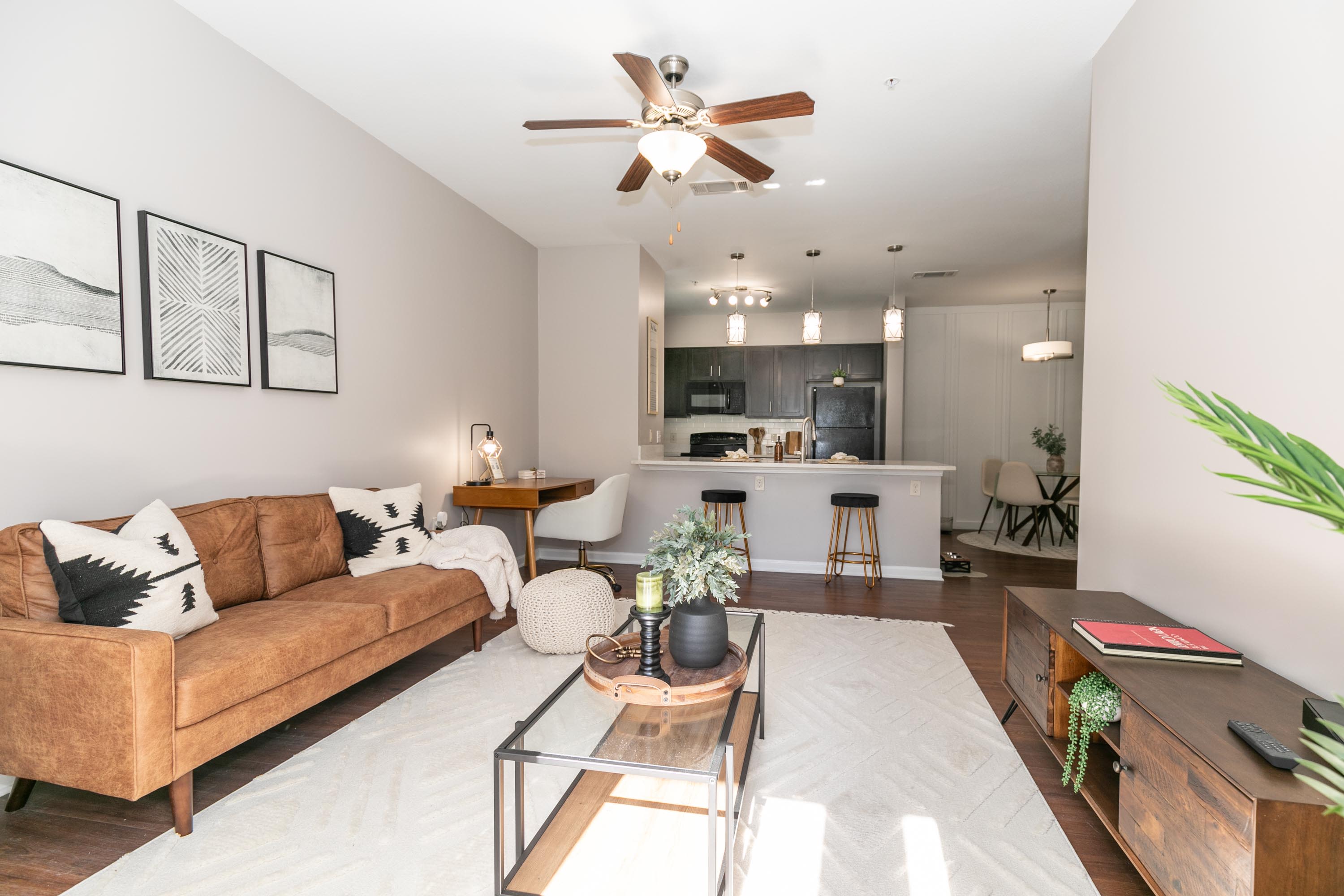Living room with a sofa, a coffee table, and a ceiling fan at Thomaston Crossing in Macon, Georgia