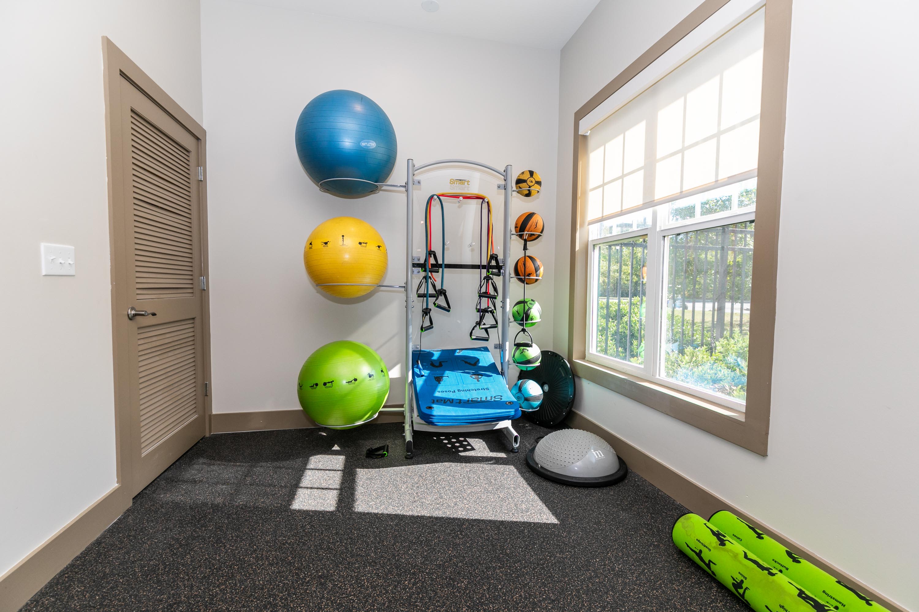 A gym room with exercise machines and gears at Thomaston Crossing in Macon, Georgia