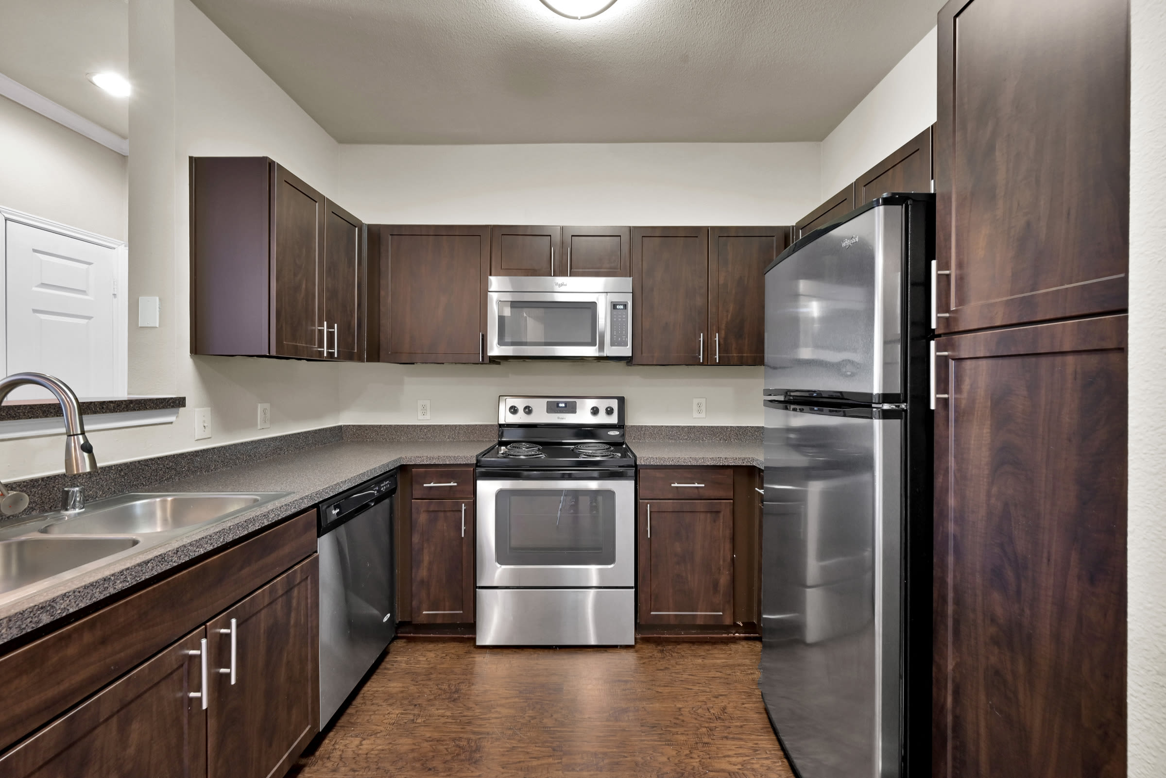 Kitchen with stainless-steel appliances at Whispering Pines Ranch in The Woodlands, Texas