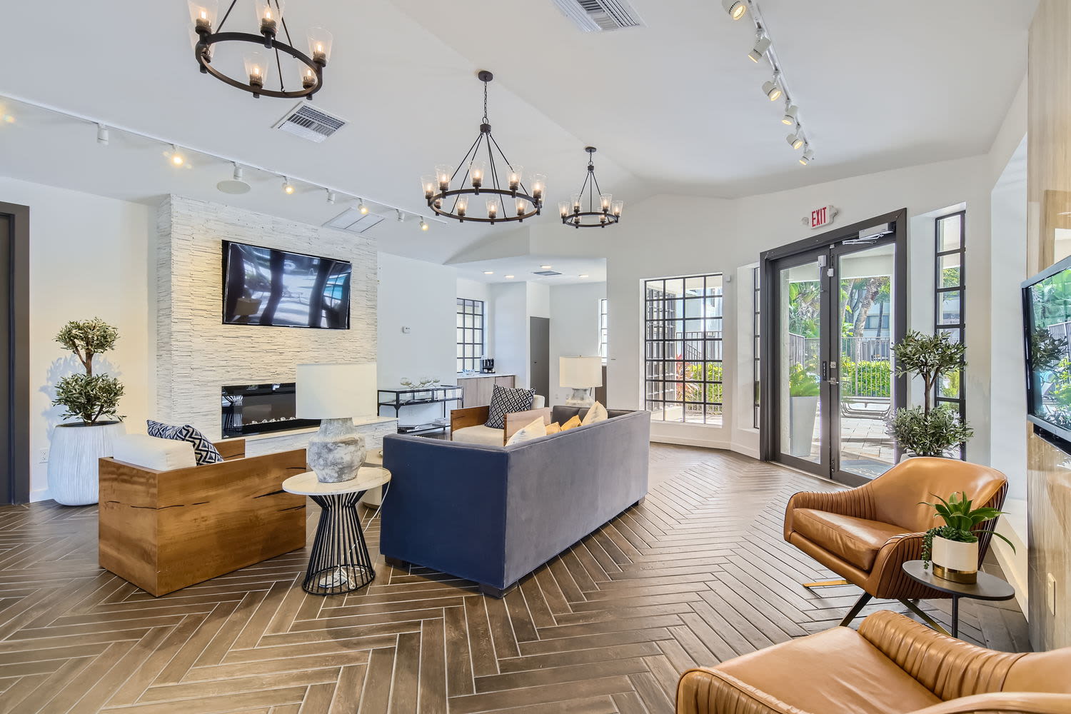 Clubhouse lounge area with television and fireplace at Cascades at the Hammocks in Miami, Florida