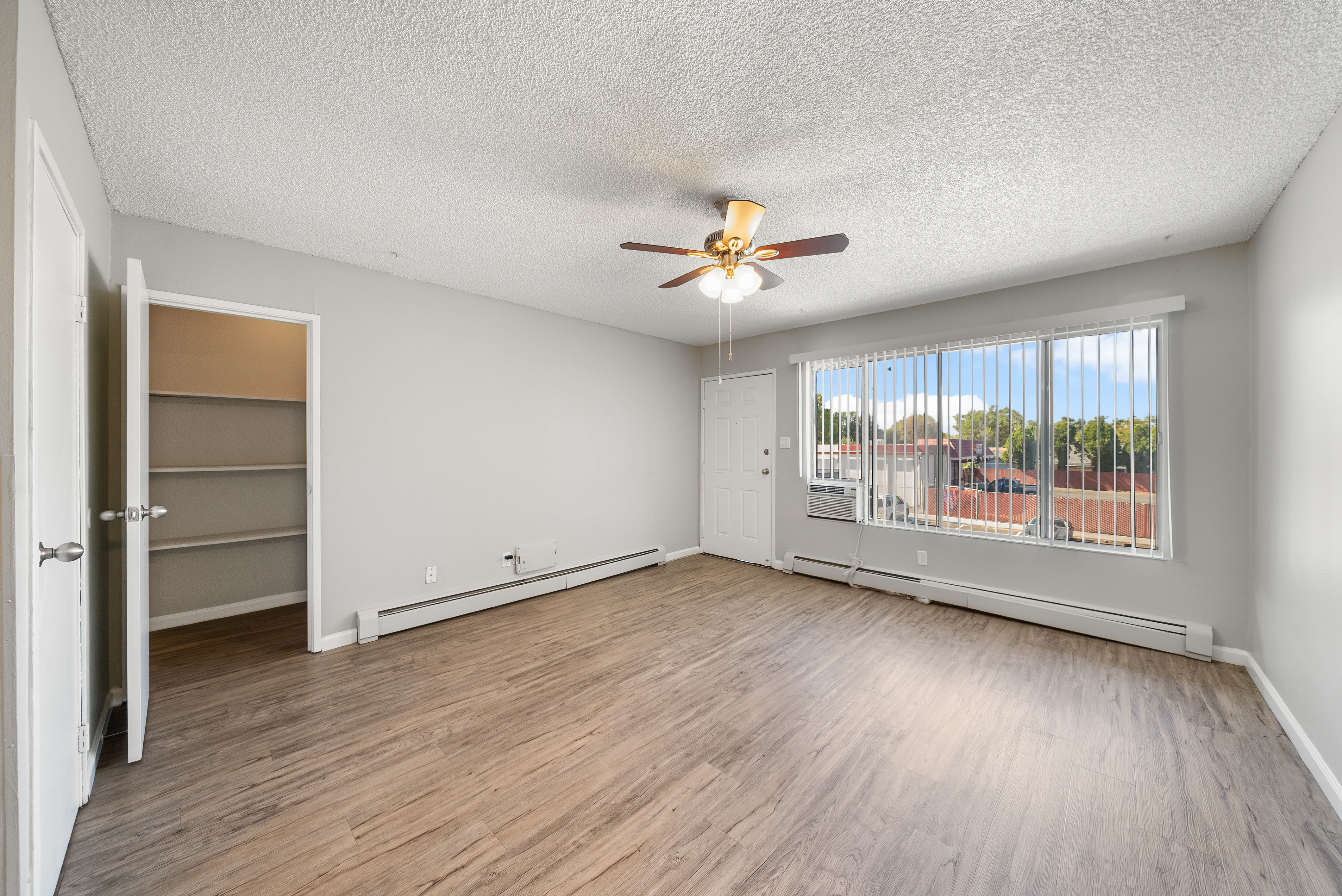 Bright living room with ceiling fan and window at The Meadows in Sparks, Nevada