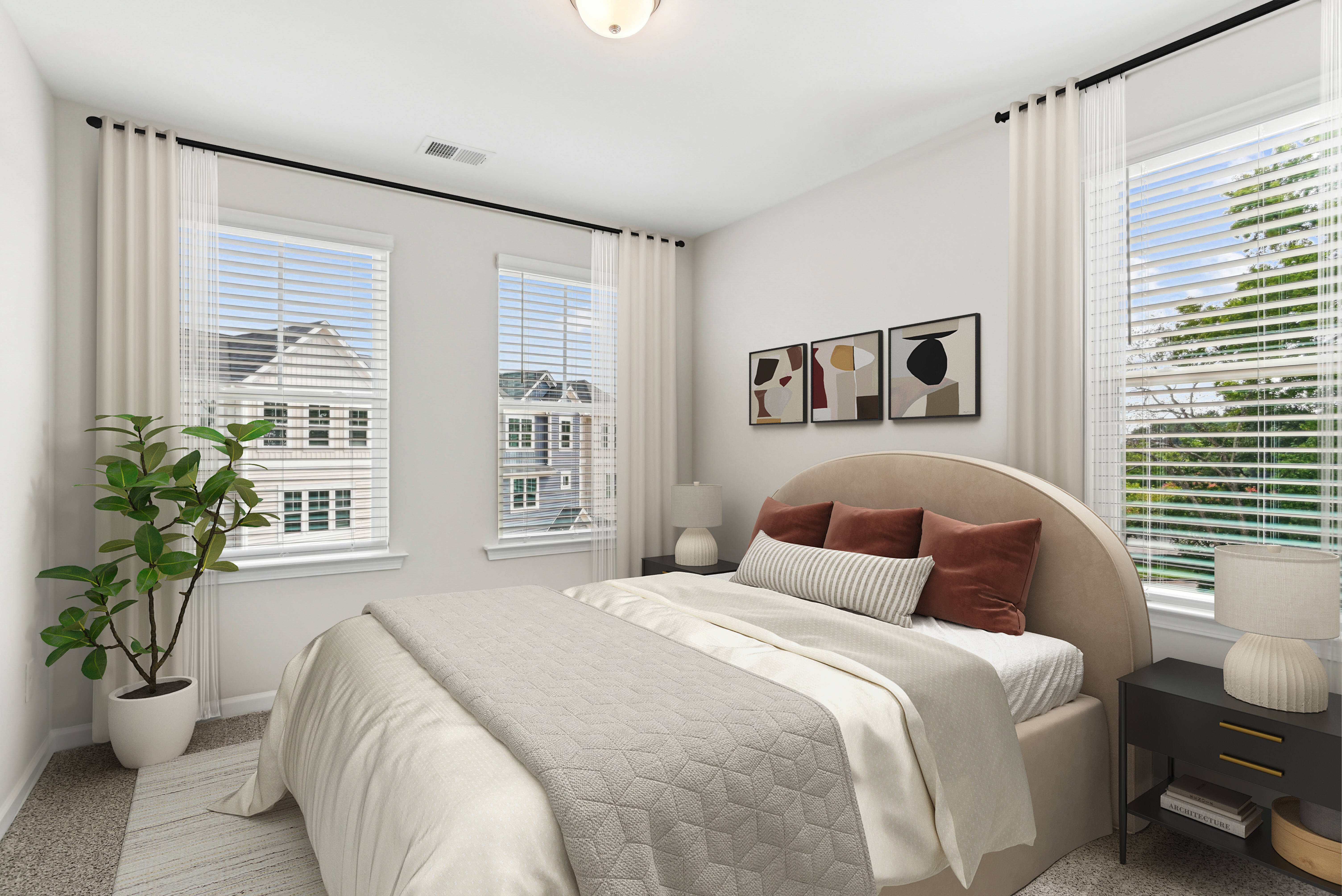 Bright bedroom with bed, night stand and windows at Westmont Village in Charlotte, North Carolina