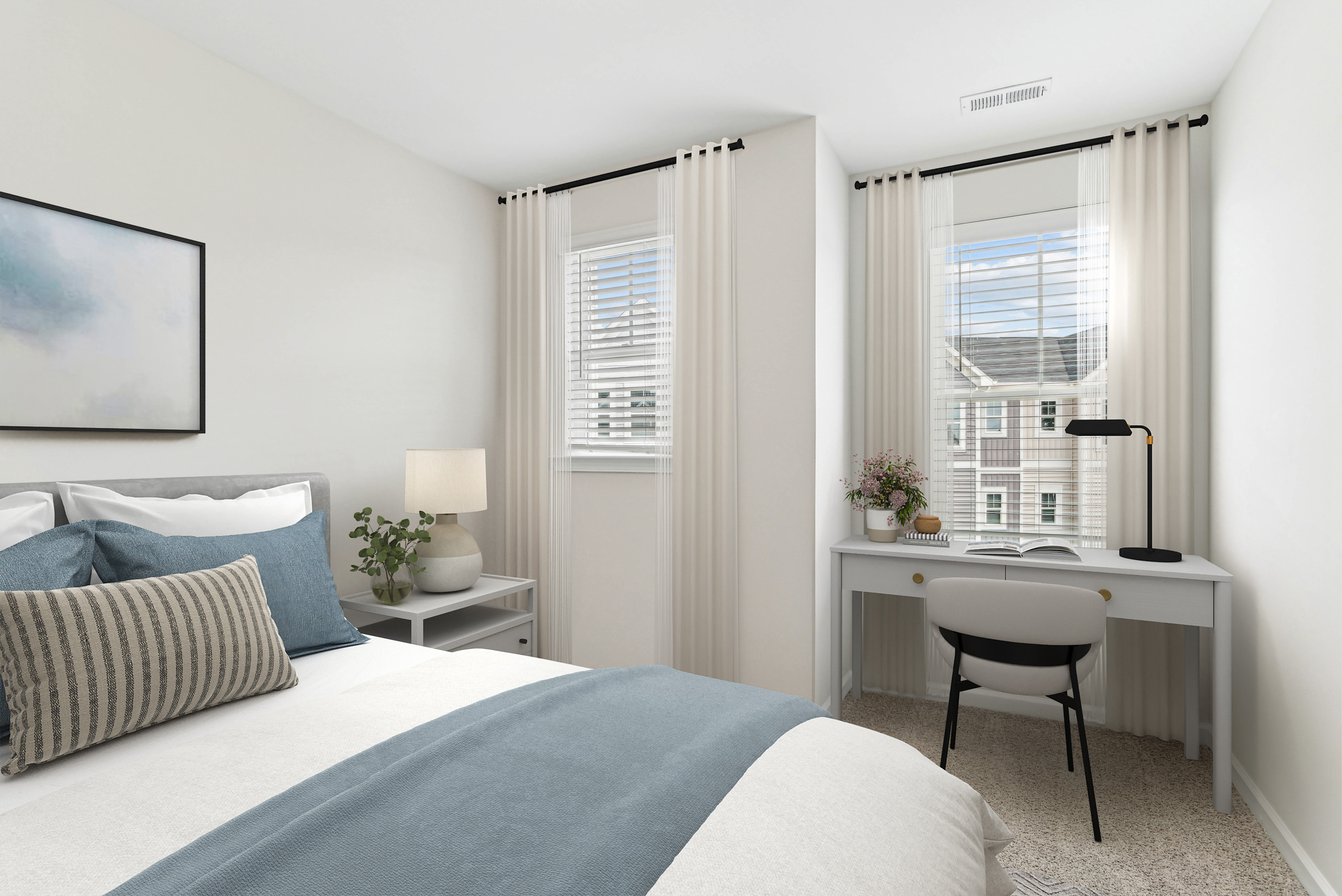 Spacious bedroom with bed, windows and a table and chair to work at Westmont Village in Charlotte, North Carolina
