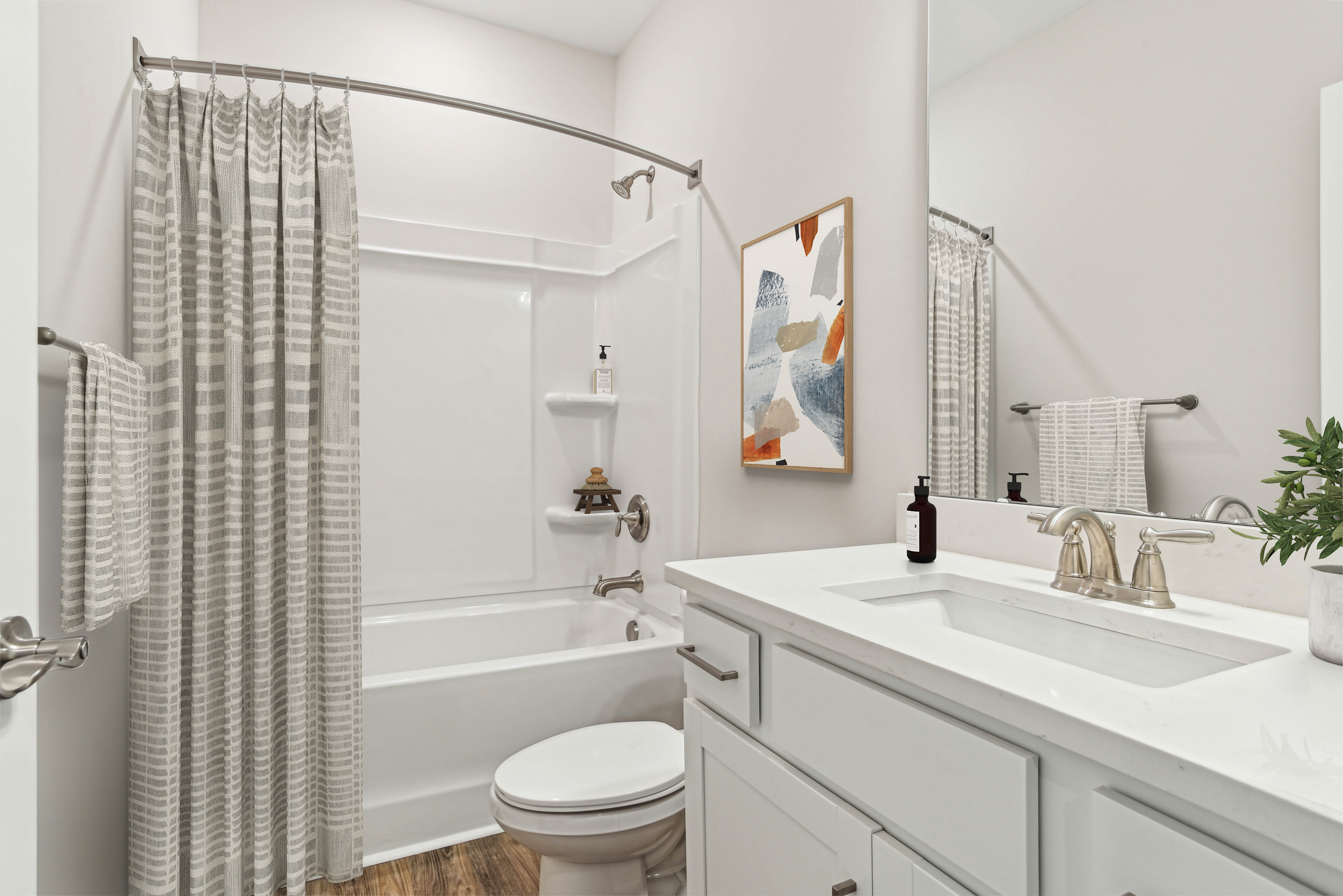 Bright bathroom with sink, tub and storage space at Westmont Village in Charlotte, North Carolina