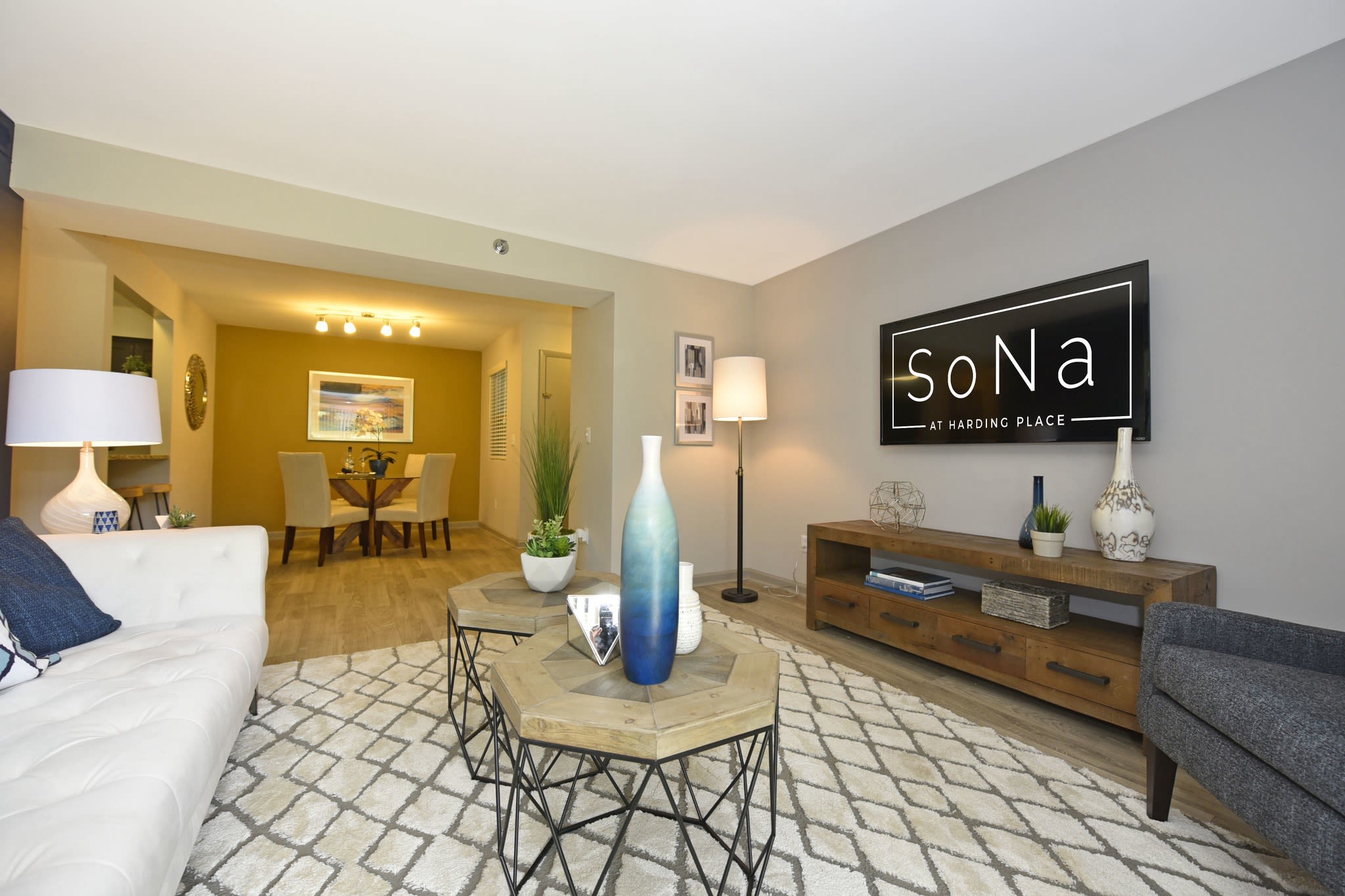 Well-furnished modern living area beside a cozy dining space at Sona at Harding in Nashville, Tennessee