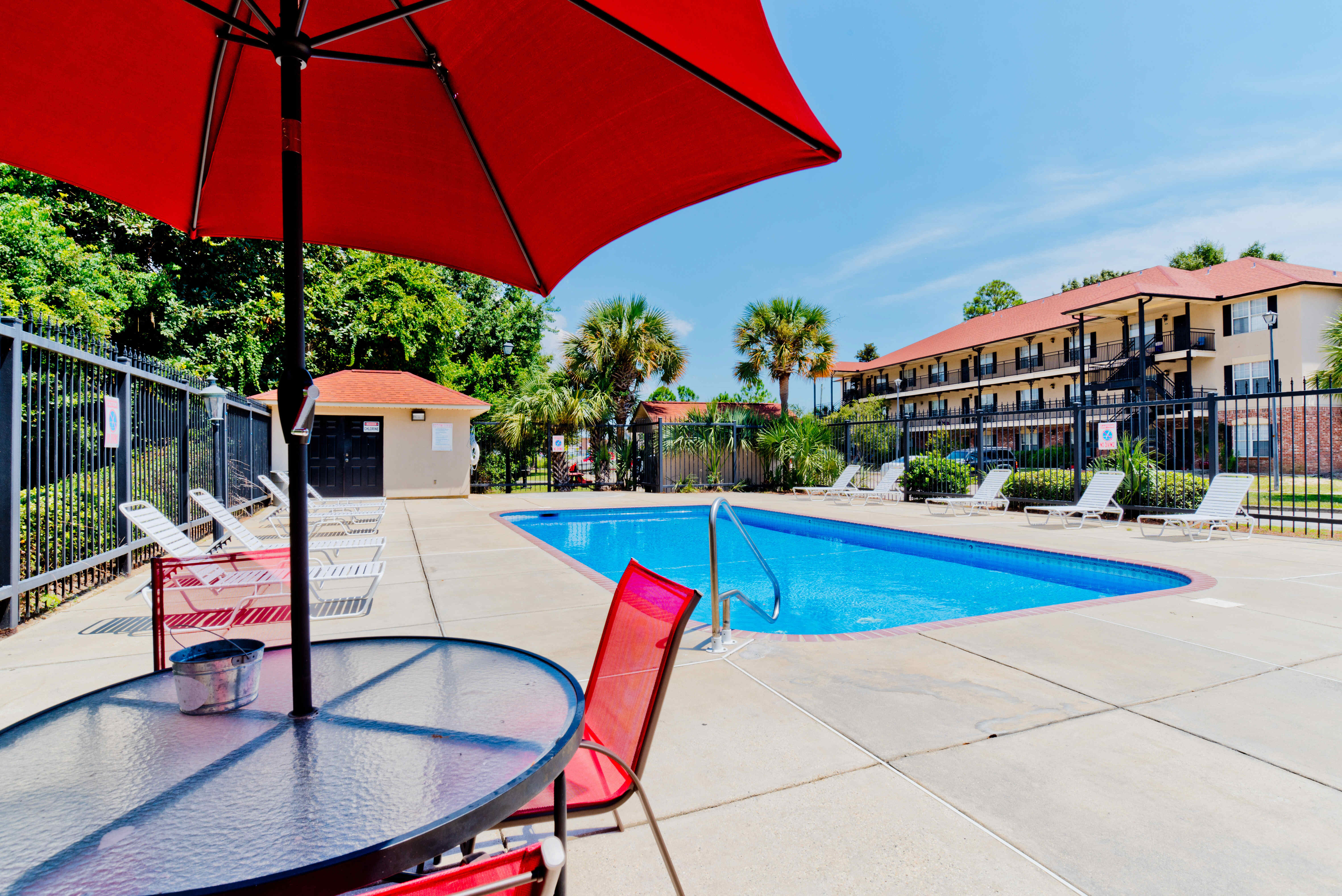 Resort-style swimming pool with a seating area by the pool at Royal Gulf Apartments in Biloxi, Mississippi