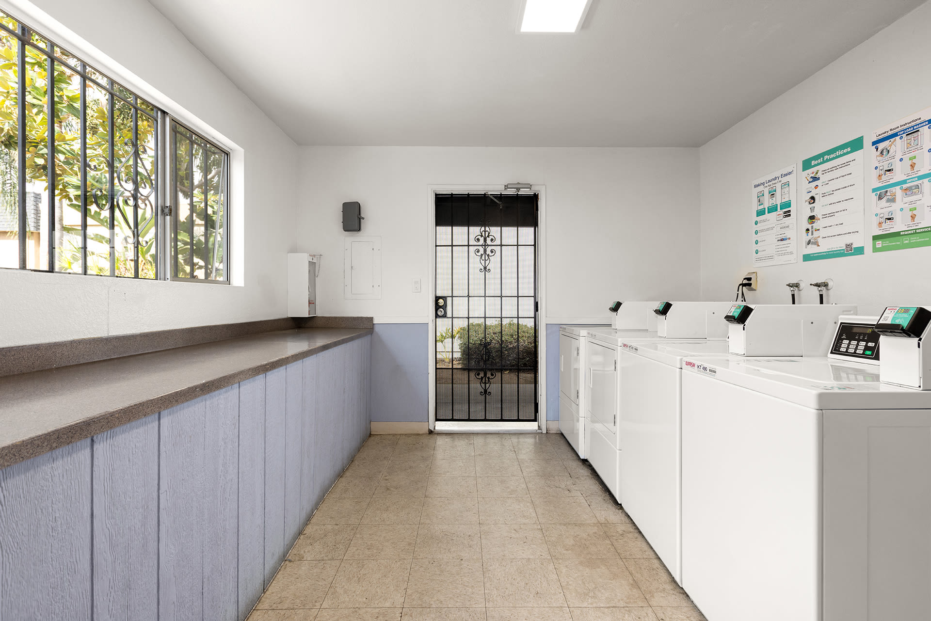 A clean and organized laundry room showcasing multiple washers and dryers at Terre at S Anza in El Cajon, California