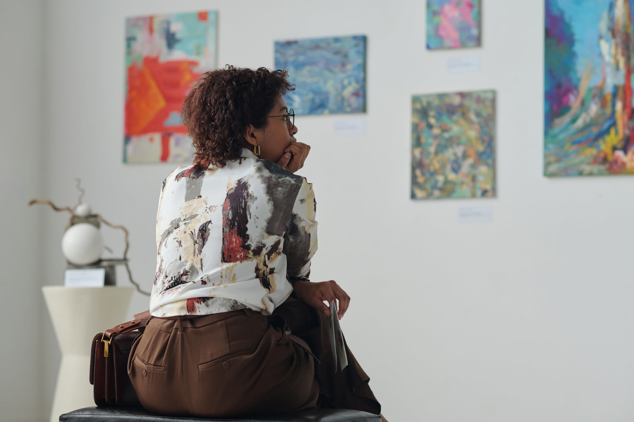 Woman looking at art gallery near Detroit Living in Detroit,