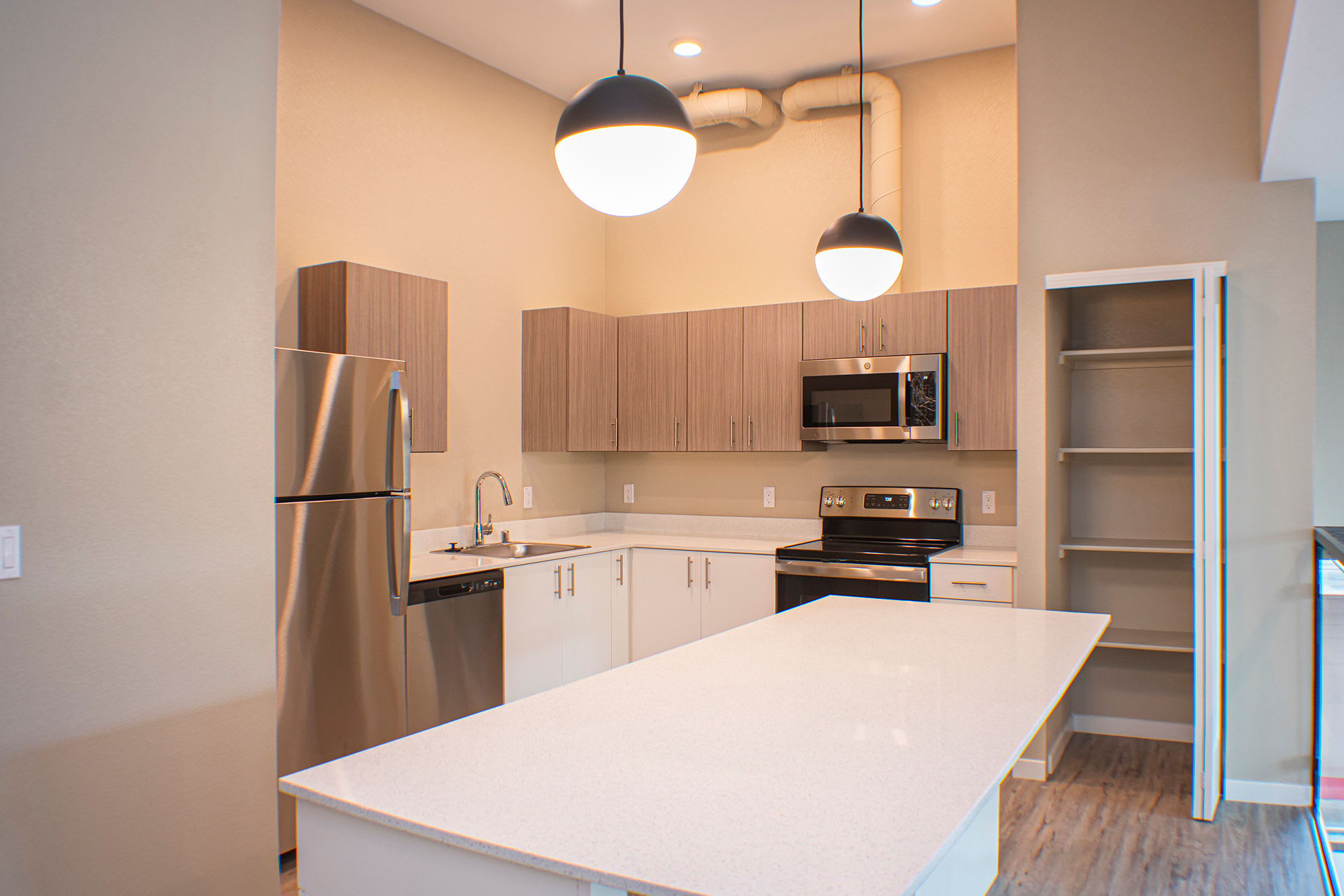 Kitchen with modern appliances in a model apartment at Eden Tower Apartments in Reno, Nevada