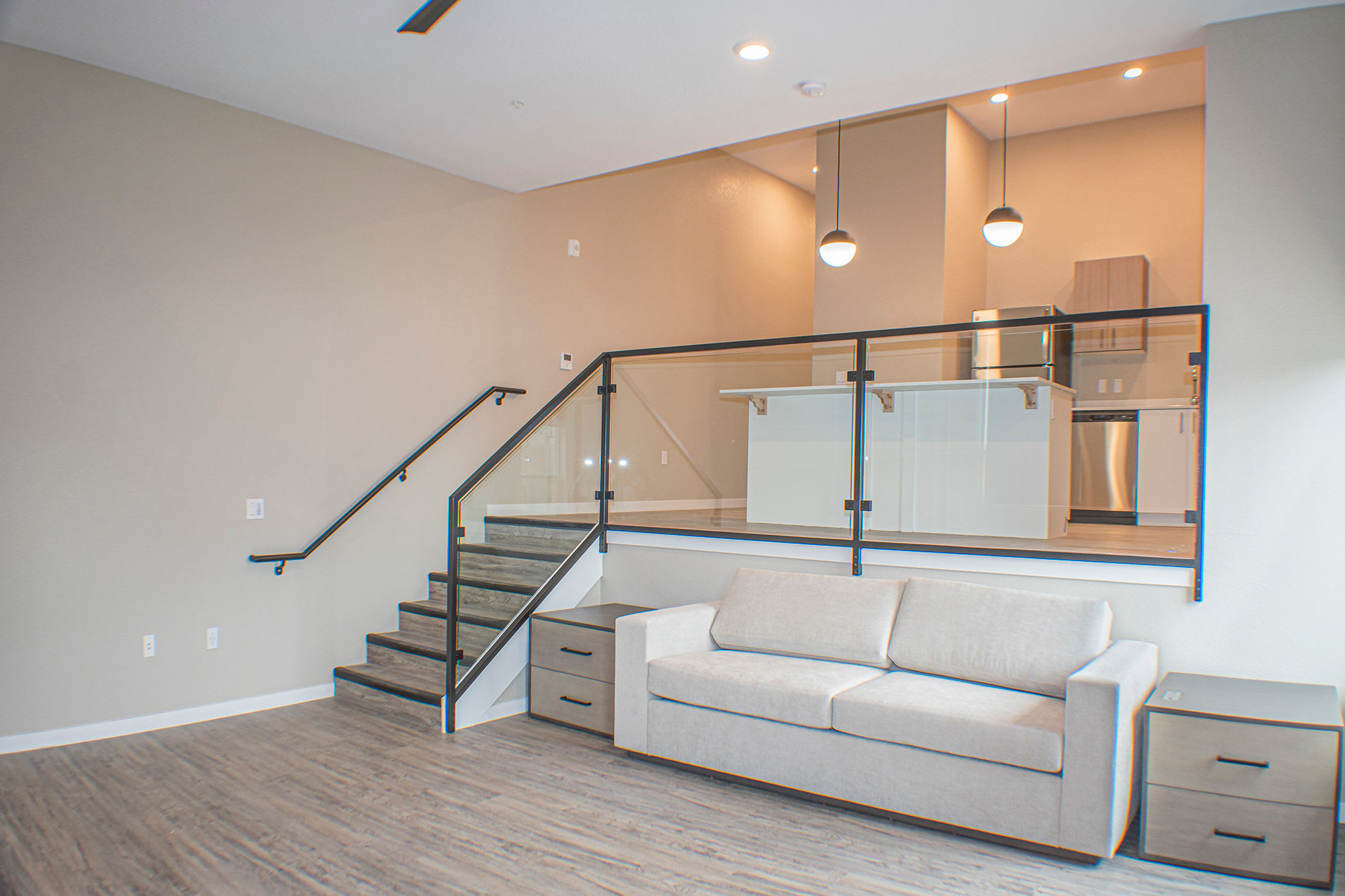 Modern living room with couch and connecting kitchen at Eden Tower Apartments in Reno, Nevada