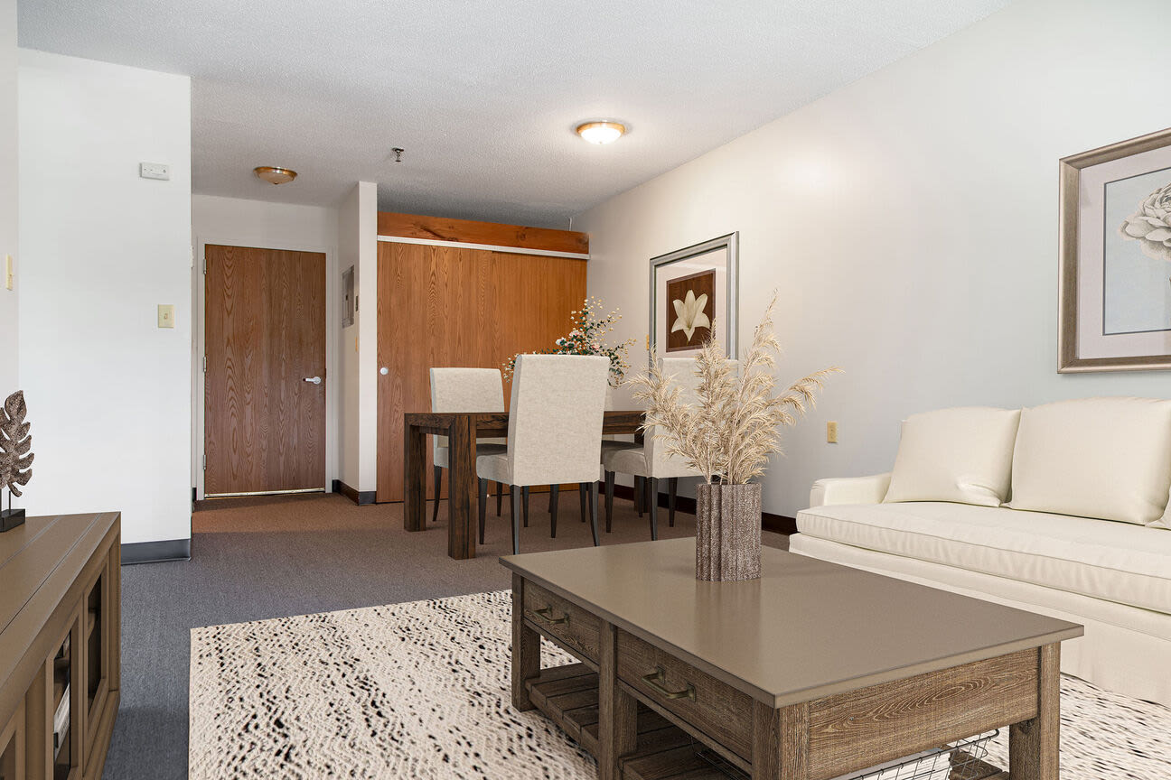 Well-furnished living area and dining space at Bedford Towers in New Bedford, Massachusetts