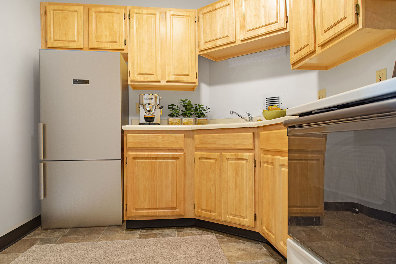 Stainless-steel appliances and wooden cabinets in the kitchen at Bedford Towers in New Bedford, Massachusetts