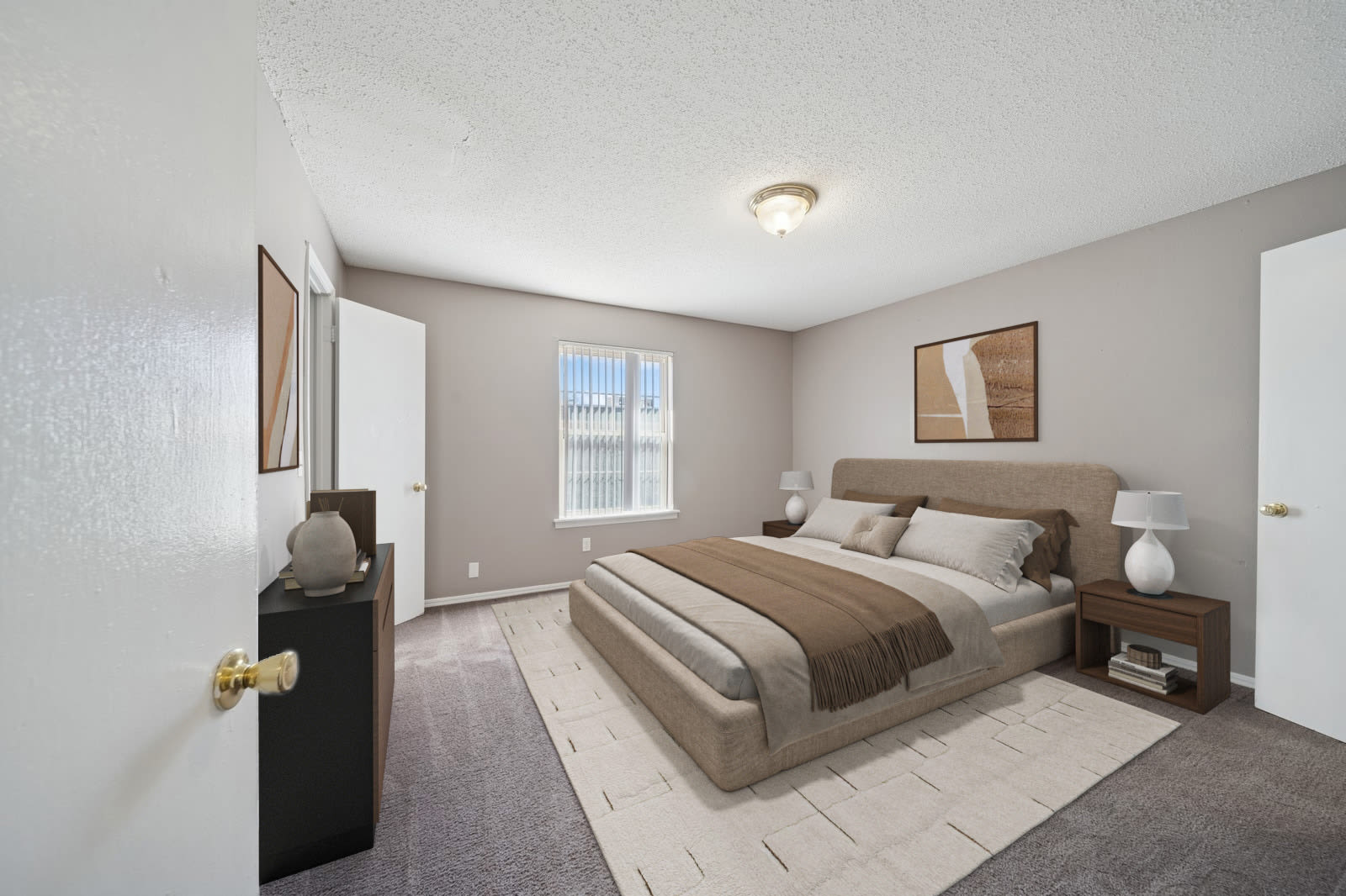 A vacant room with soft carpet and clean white walls at Reeds Landing Apartments in Edmond, Oklahoma