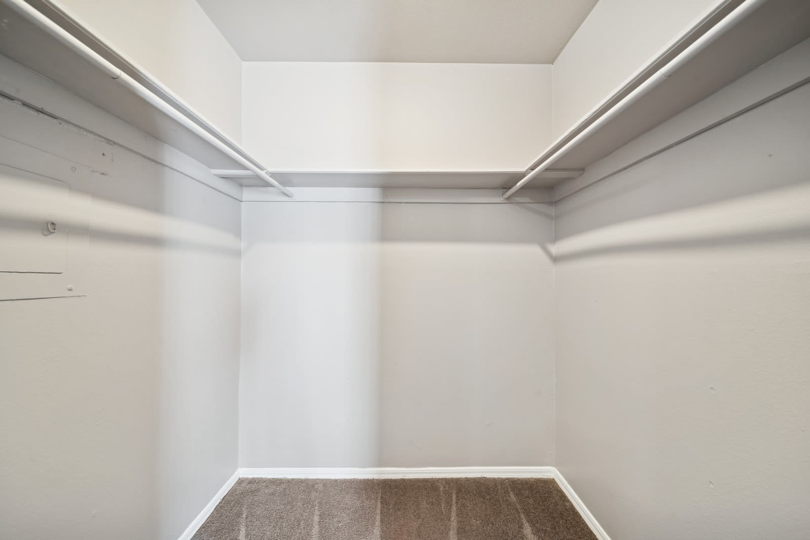 A walk-in closet with shelves at Reeds Landing Apartments in Edmond, Oklahoma