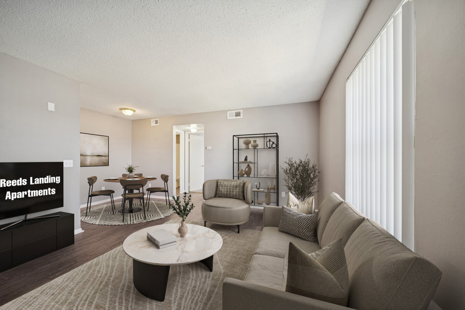 An apartment room with polished hardwood floors and a plain white door at Reeds Landing Apartments in Edmond, Oklahoma