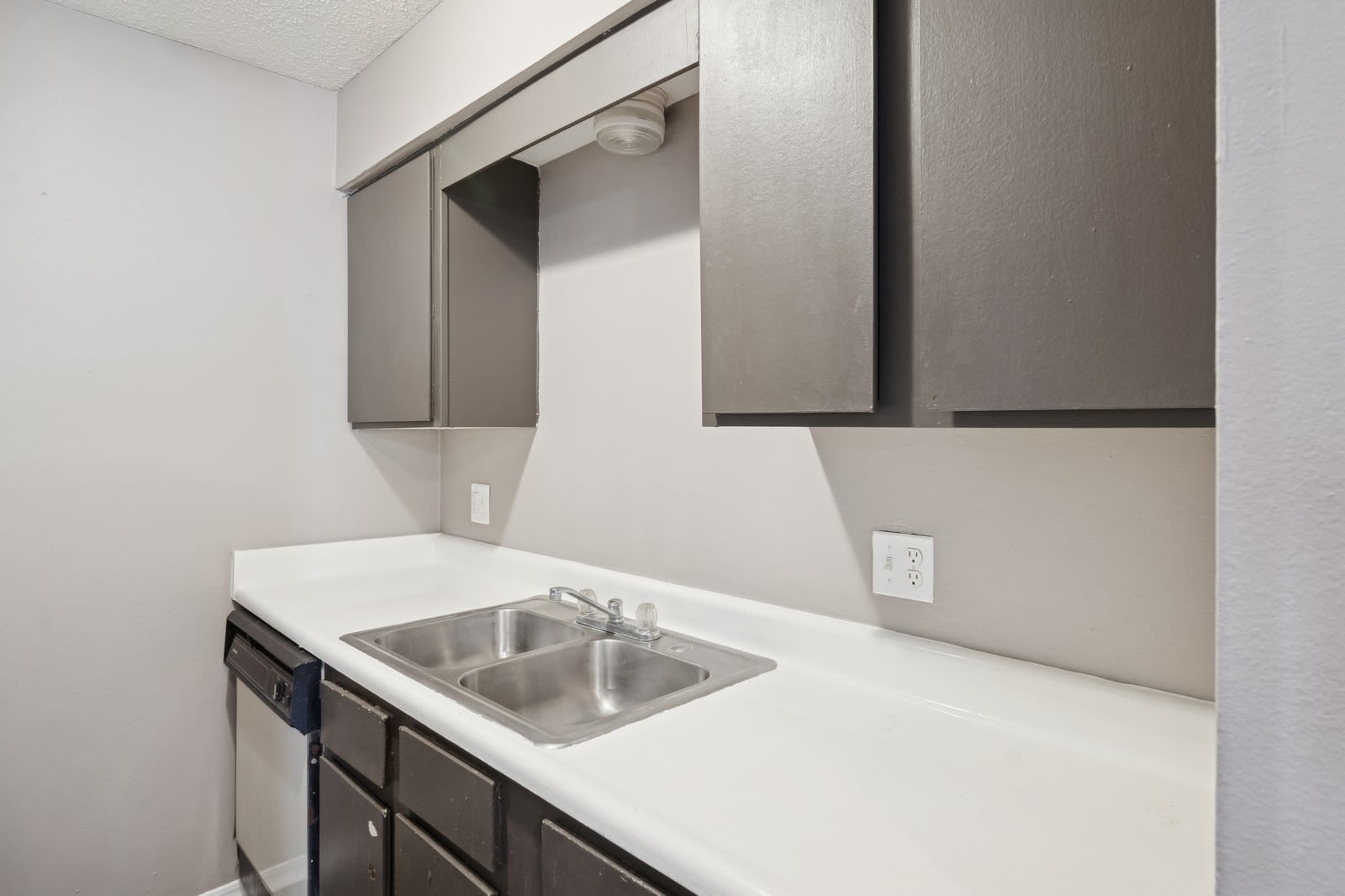 A kitchen with a sink and cabinets at Reeds Landing Apartments in Edmond, Oklahoma