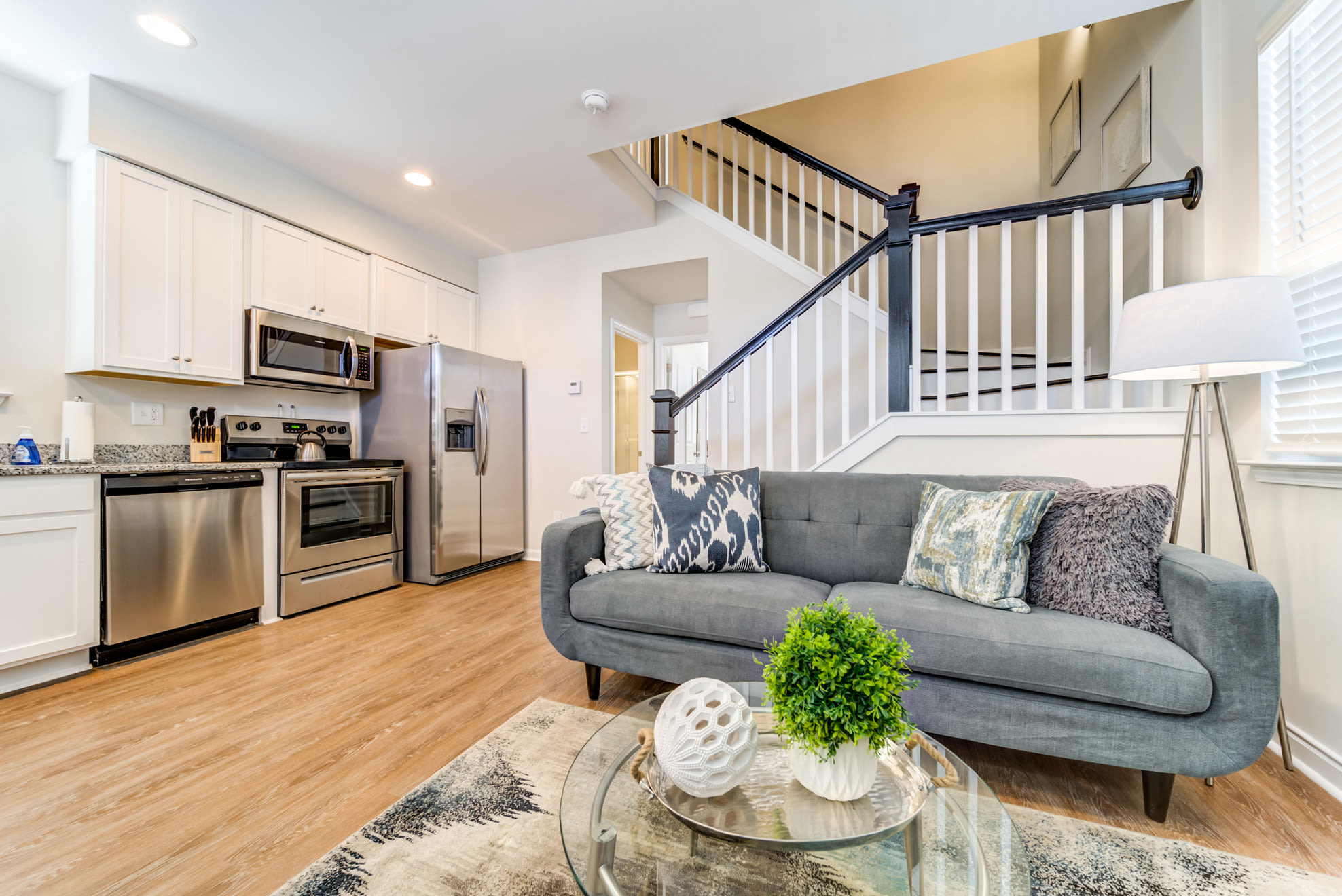 Modern kitchen with stainless steel appliances and connecting living room at Seaglass Cottage in North Myrtle Beach, South Carolina