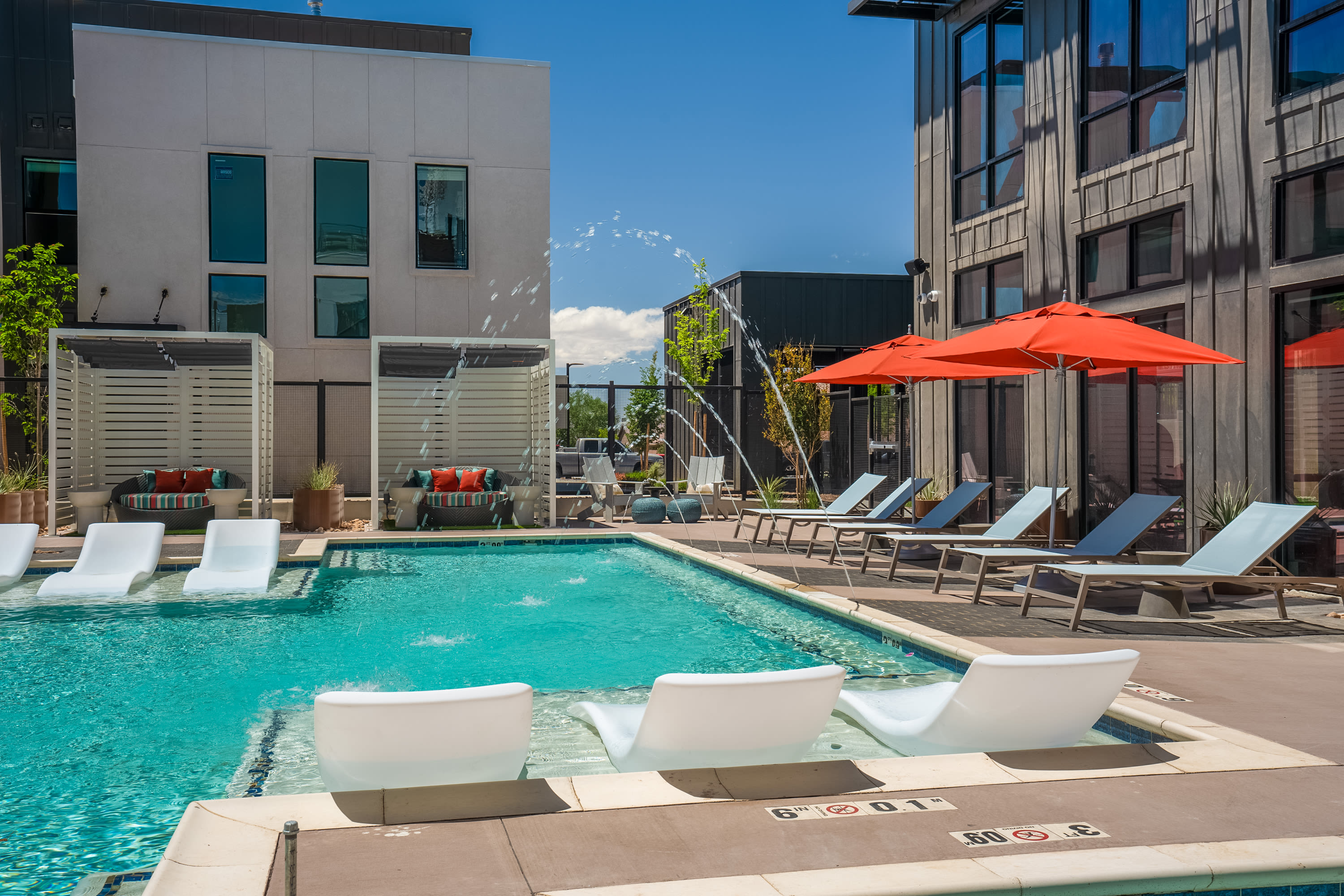 Swimming pool with lounge chairs at Olympus Latitude in Albuquerque, New Mexico