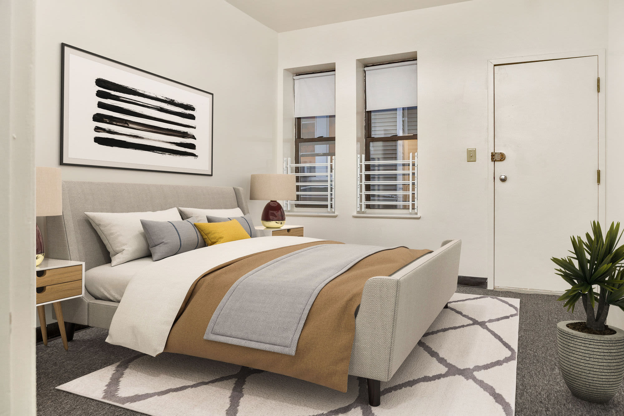 Spacious bedroom with cozy bed and window at Commerce Apartments in Roxbury, Massachusetts