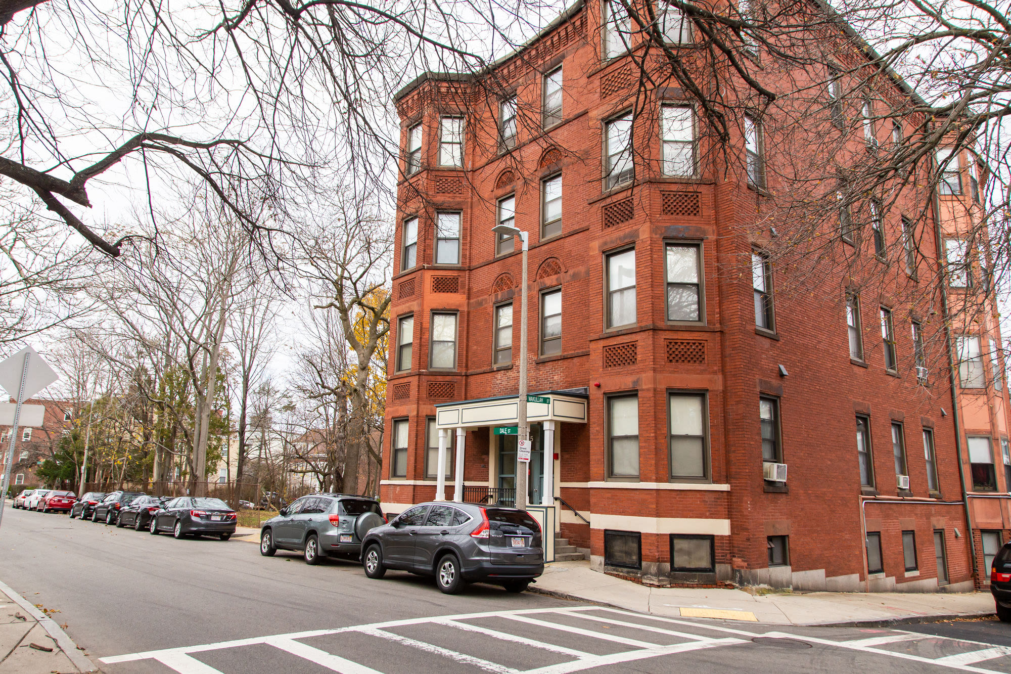 View of apartment with car parked at Commerce Apartments in Roxbury, Massachusetts