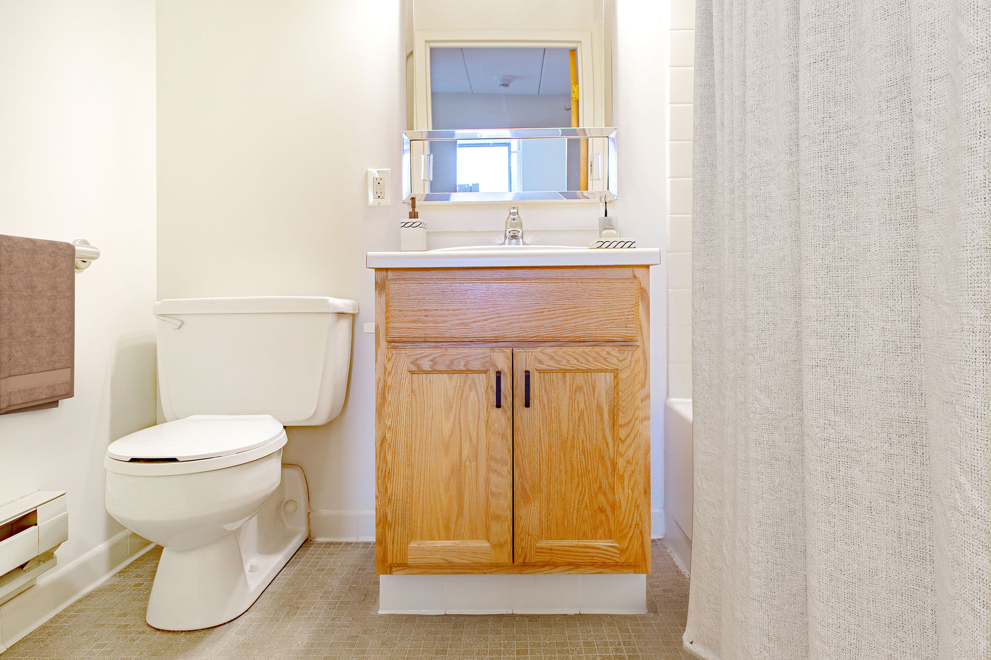 Bright bathroom with mirror at Clark House in Amherst, Massachusetts, 