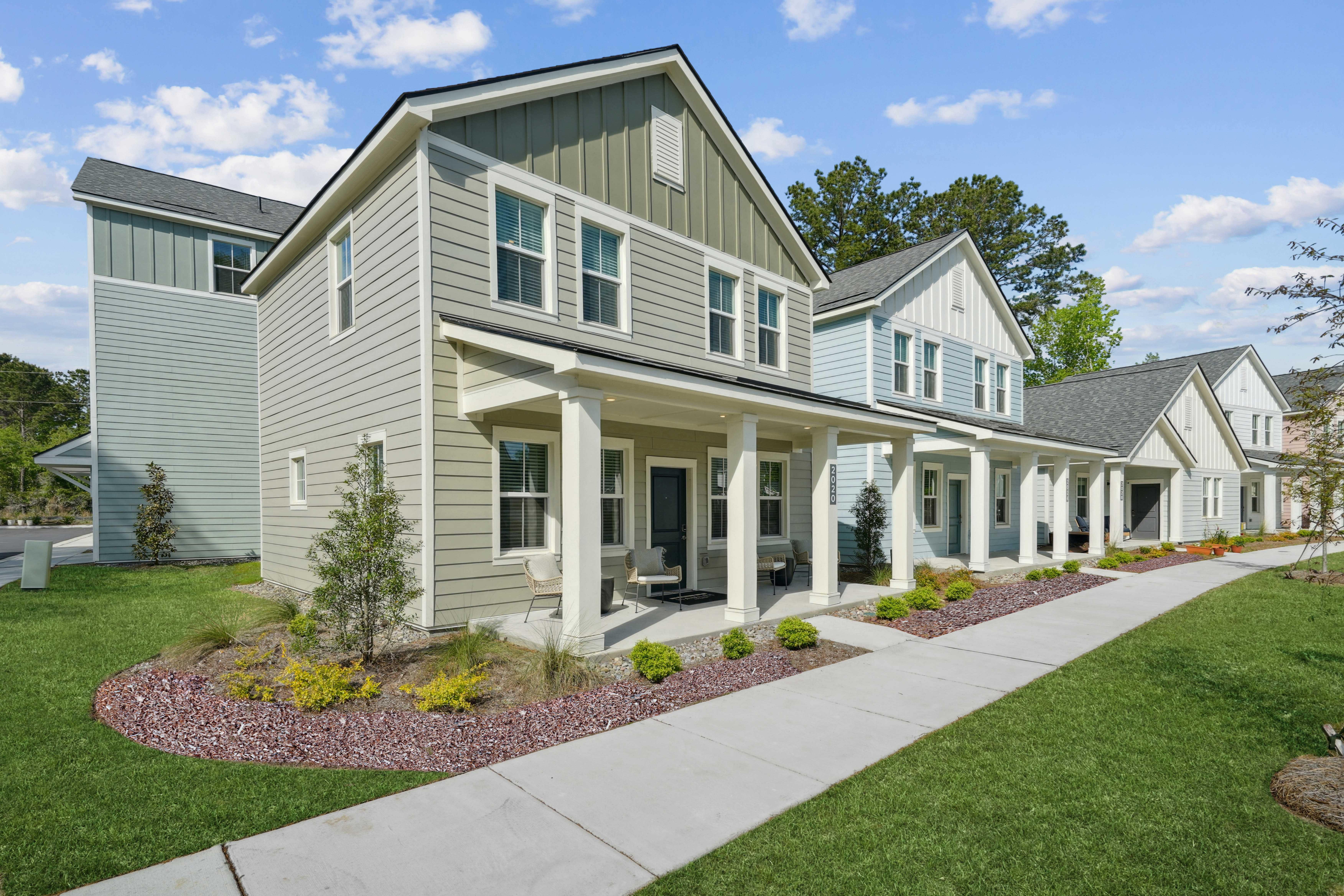 Grass-lined path outside homes at Hamlet at Avalon Park in Wesley Chapel, Florida