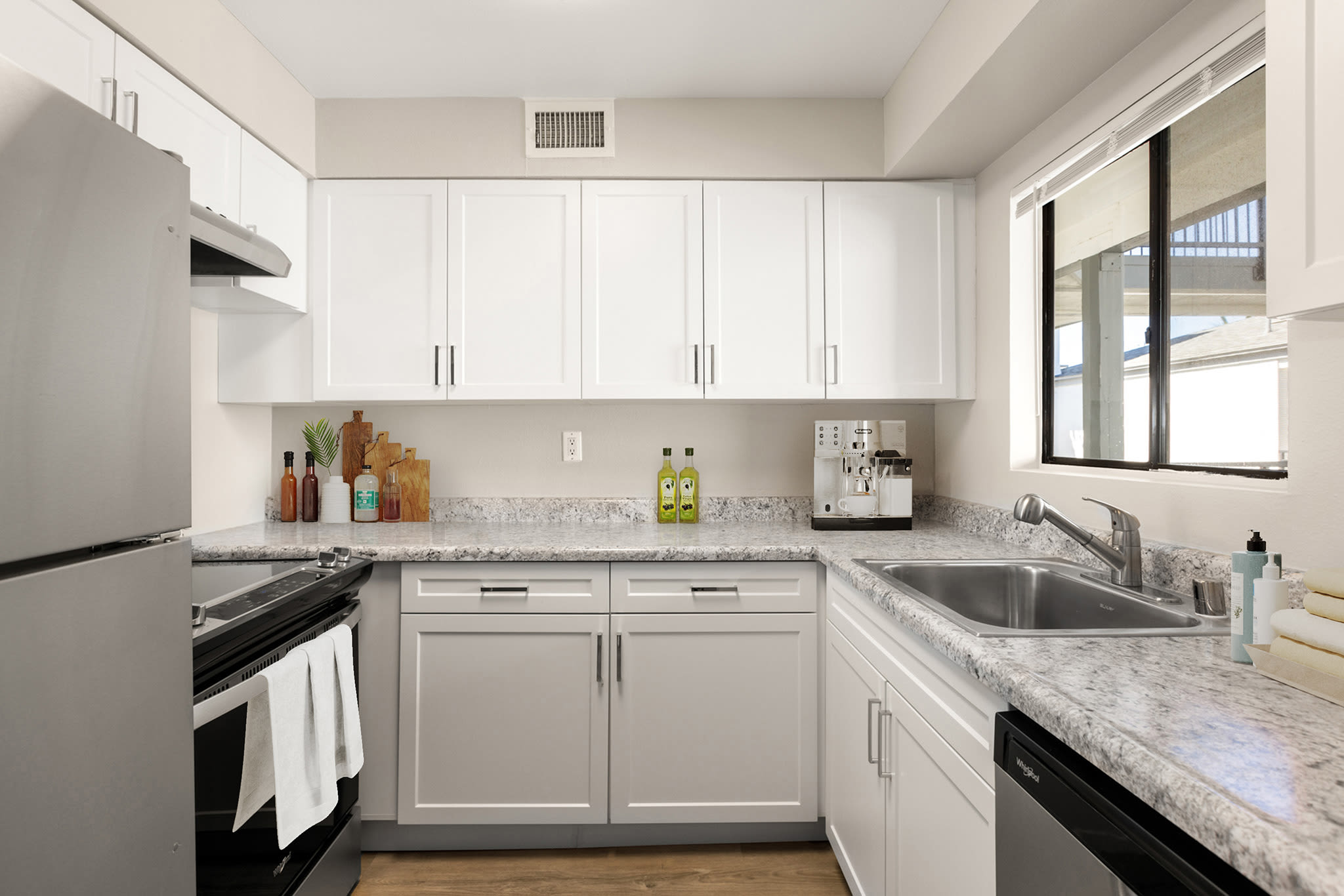 Kitchen window to living space at Plaza at Canoga Park in Canoga Park, California