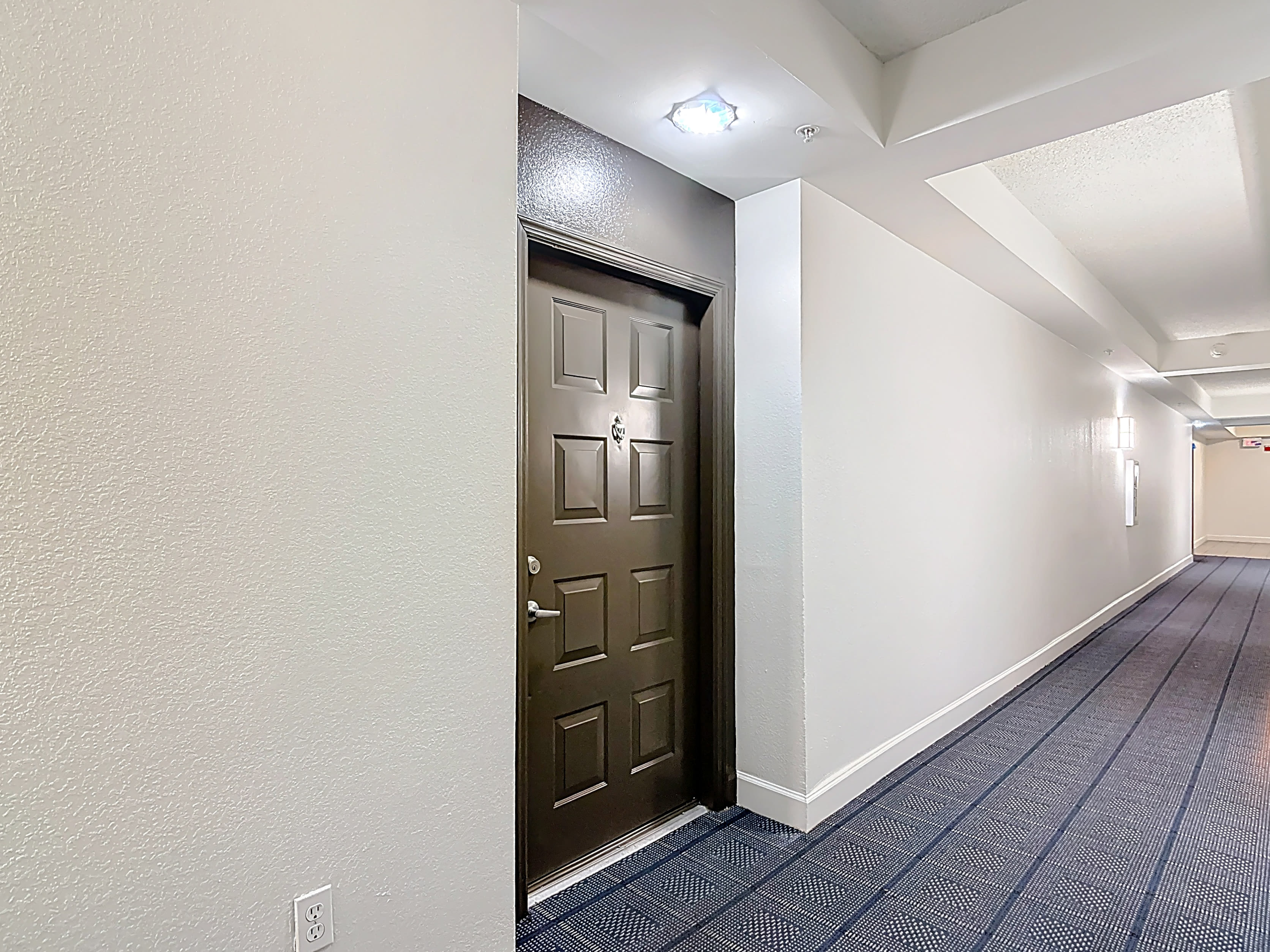 Hallway with a door at one end at Valencia South Miami in South Miami, Florida