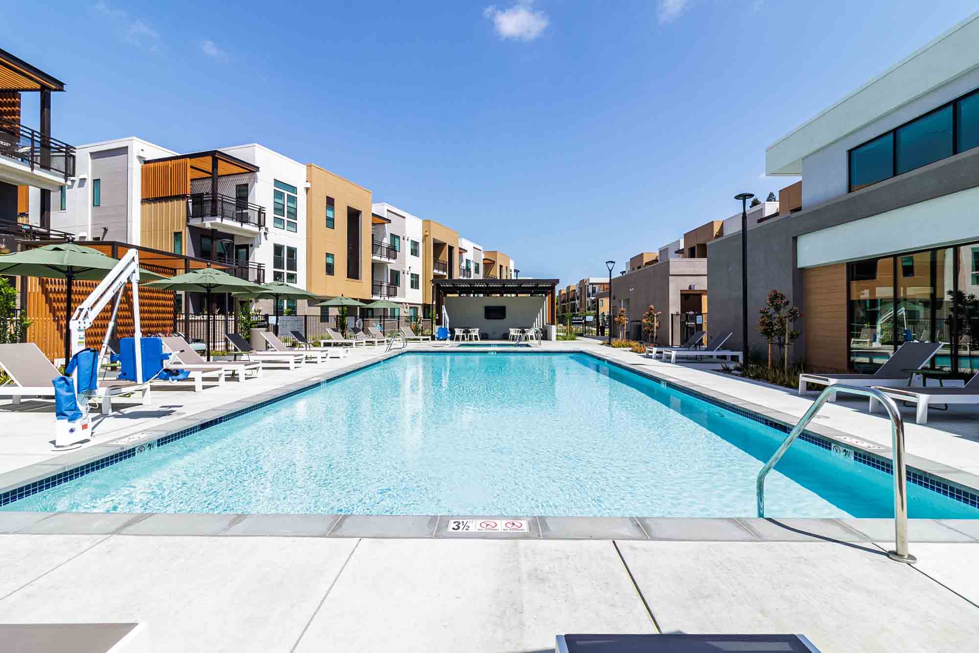 Entrance with Pool view at Sutter Green Apartments in Sacramento, California
