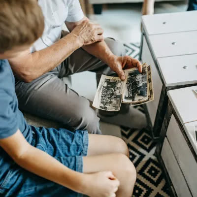 Resident showing a grandchild some old photos
